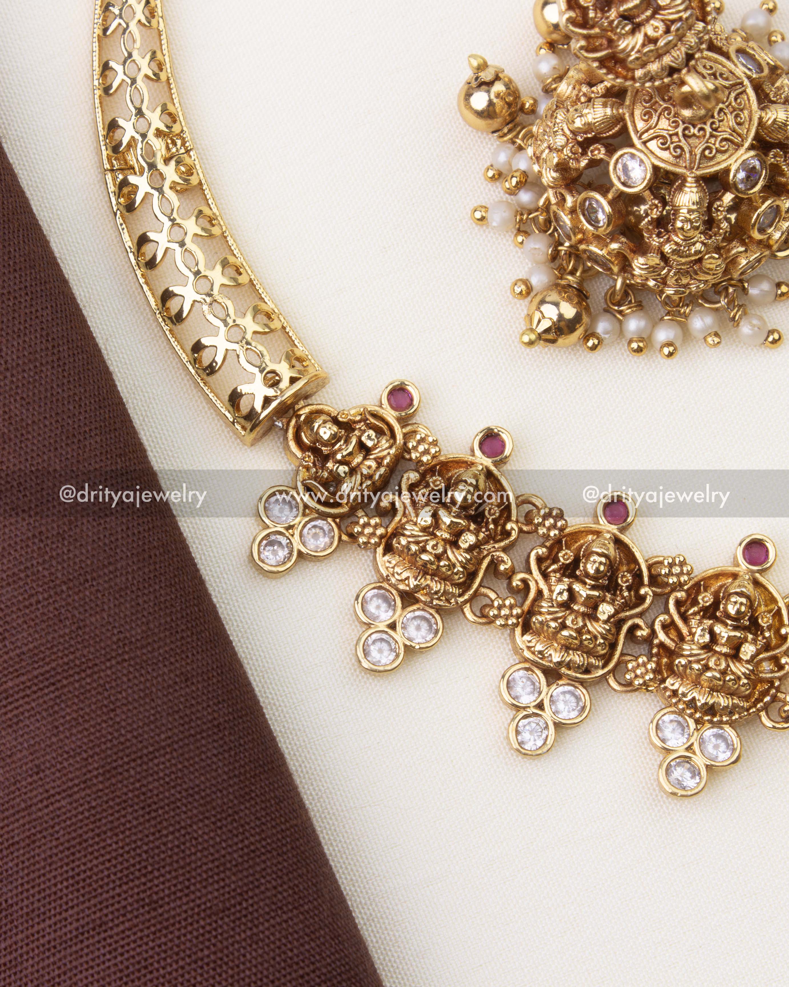 Close-up of Lakshmi motif temple necklace with antique gold polish and pearl hangings