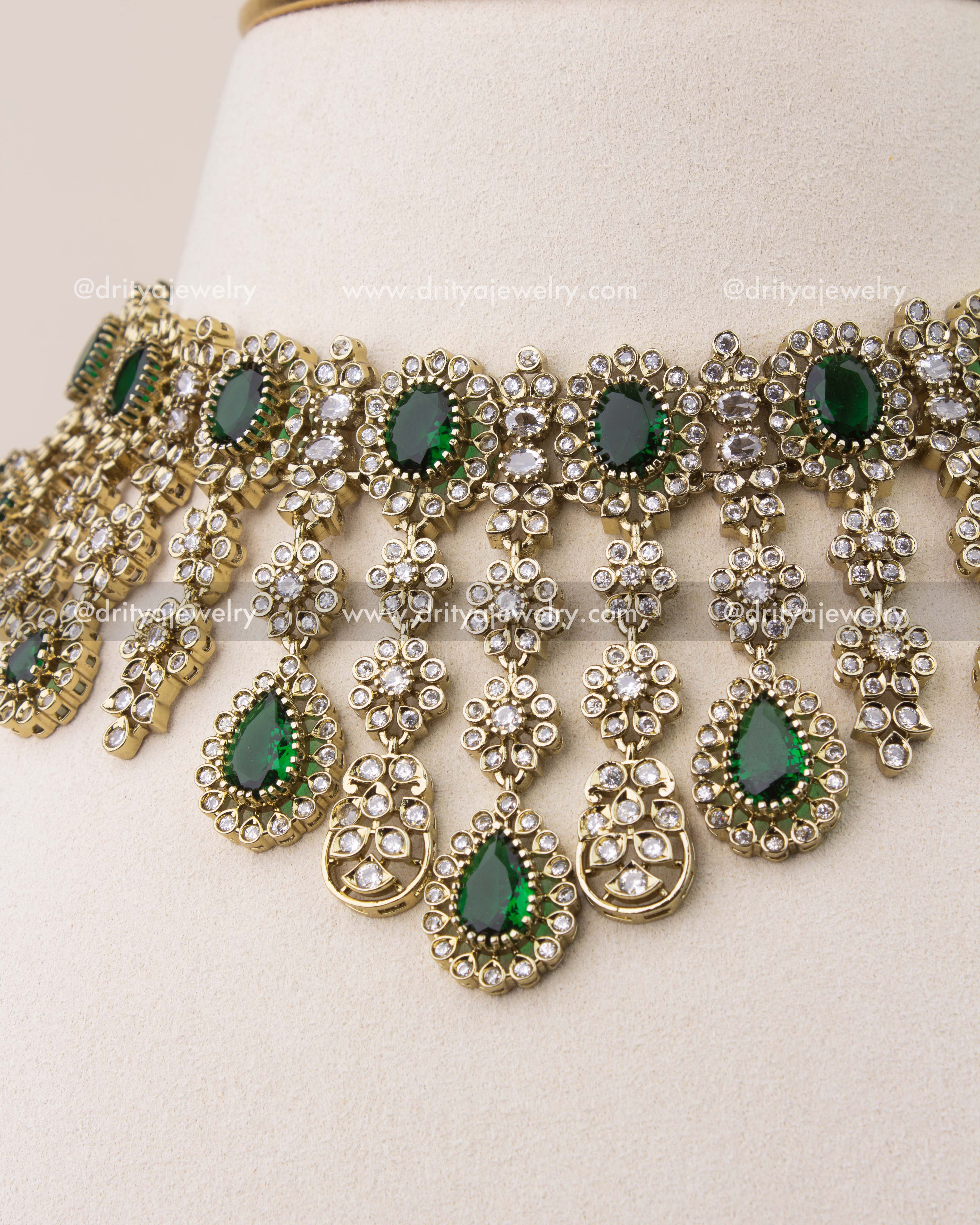 Close-up of emerald green stones and diamond-like CZ work in Victorian necklace