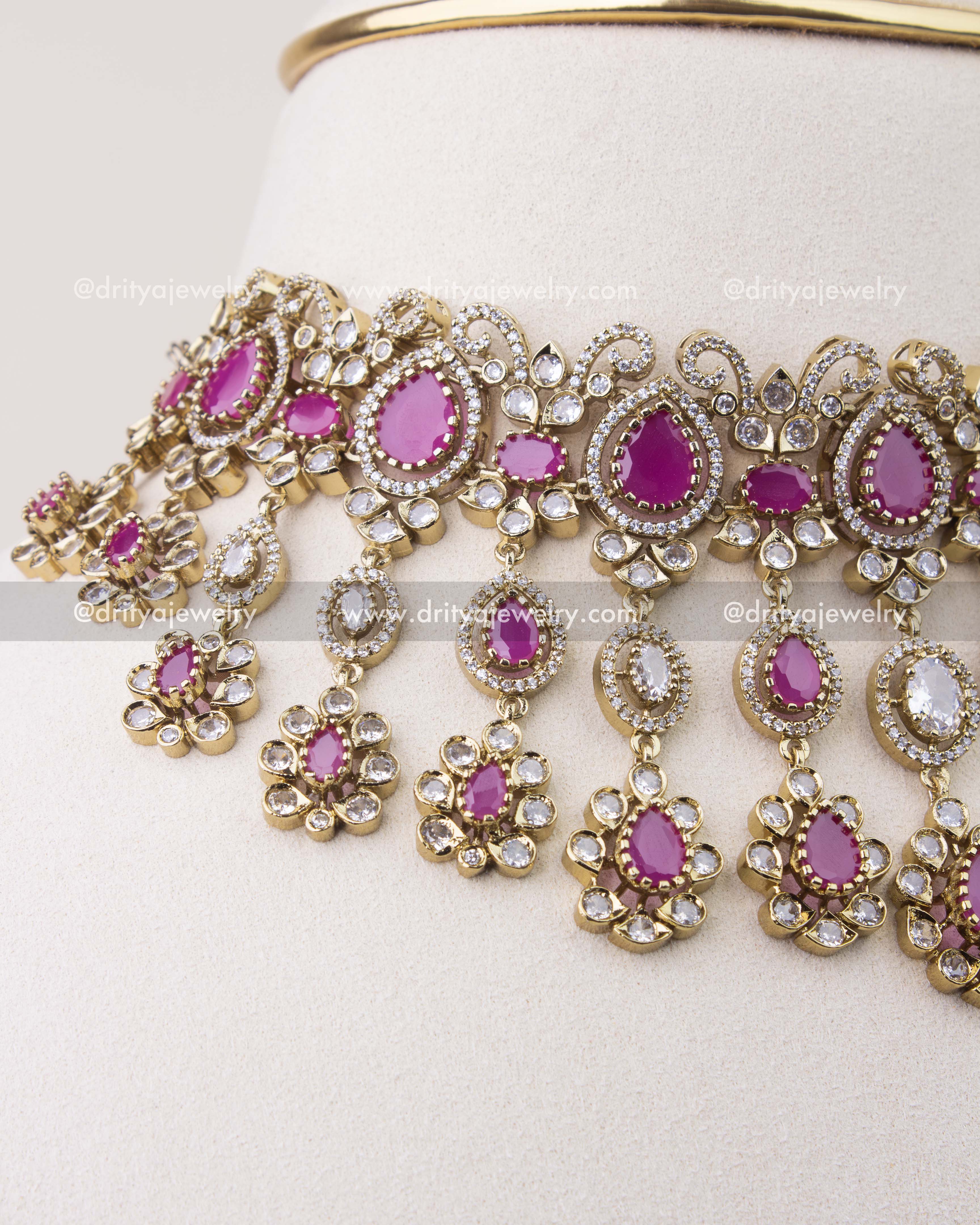 Close-up of ruby pink Victorian choker with intricate CZ stone work and hanging motifs