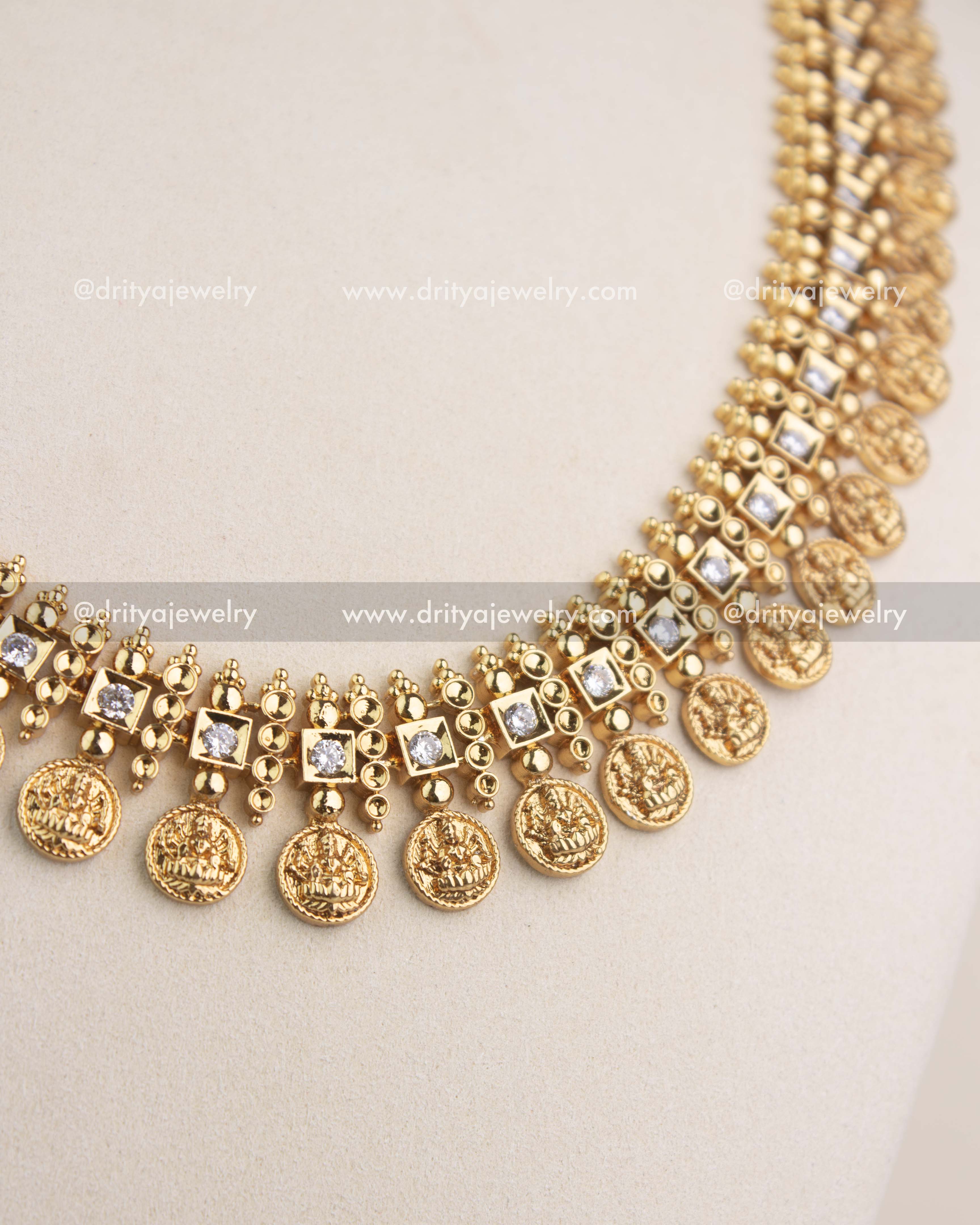High-detail close-up highlighting embossed Lakshmi coins and beadwork on the temple necklace.