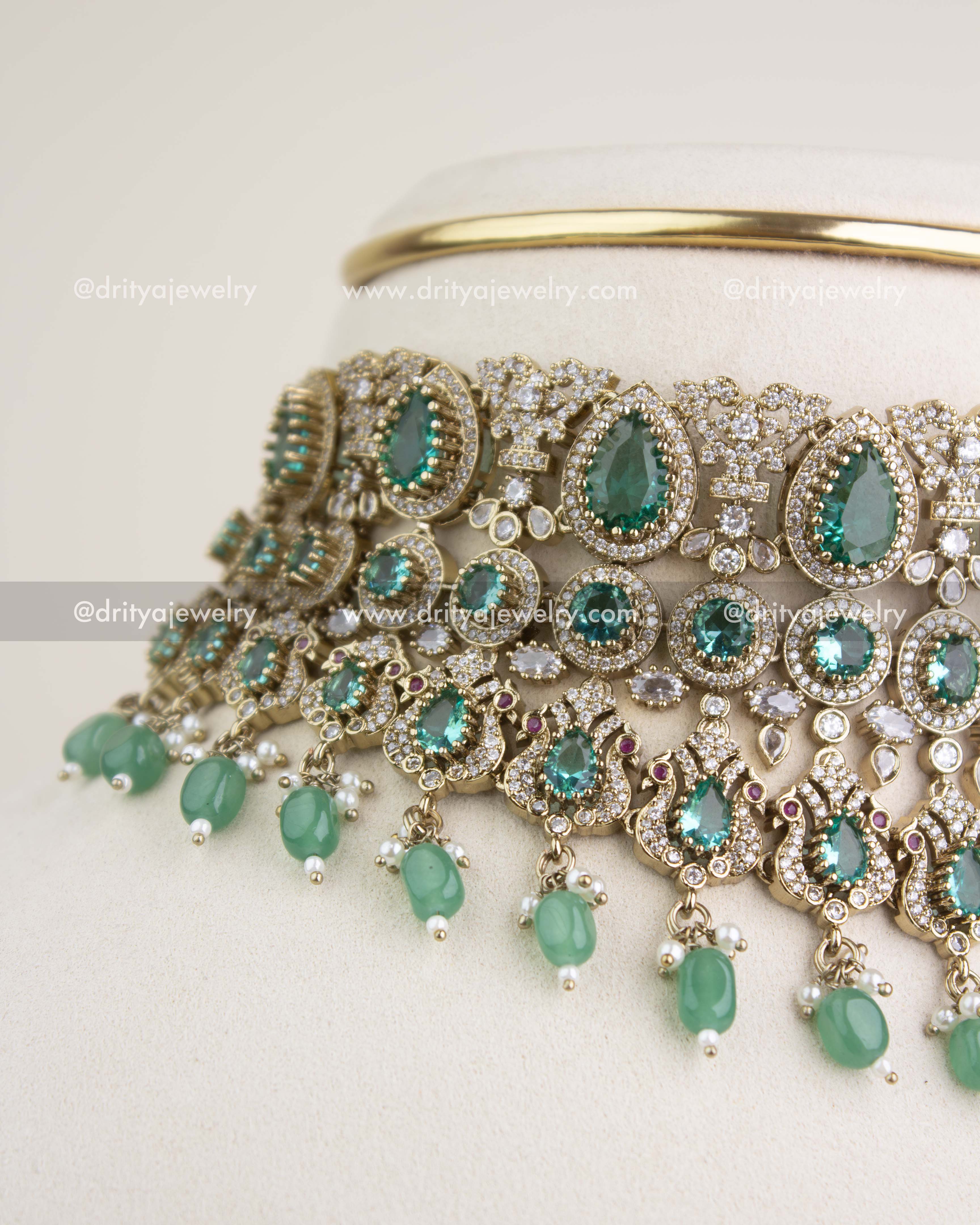 Close-up view of Russian emerald stones, teardrop motifs, and intricate Victorian filigree craftsmanship.