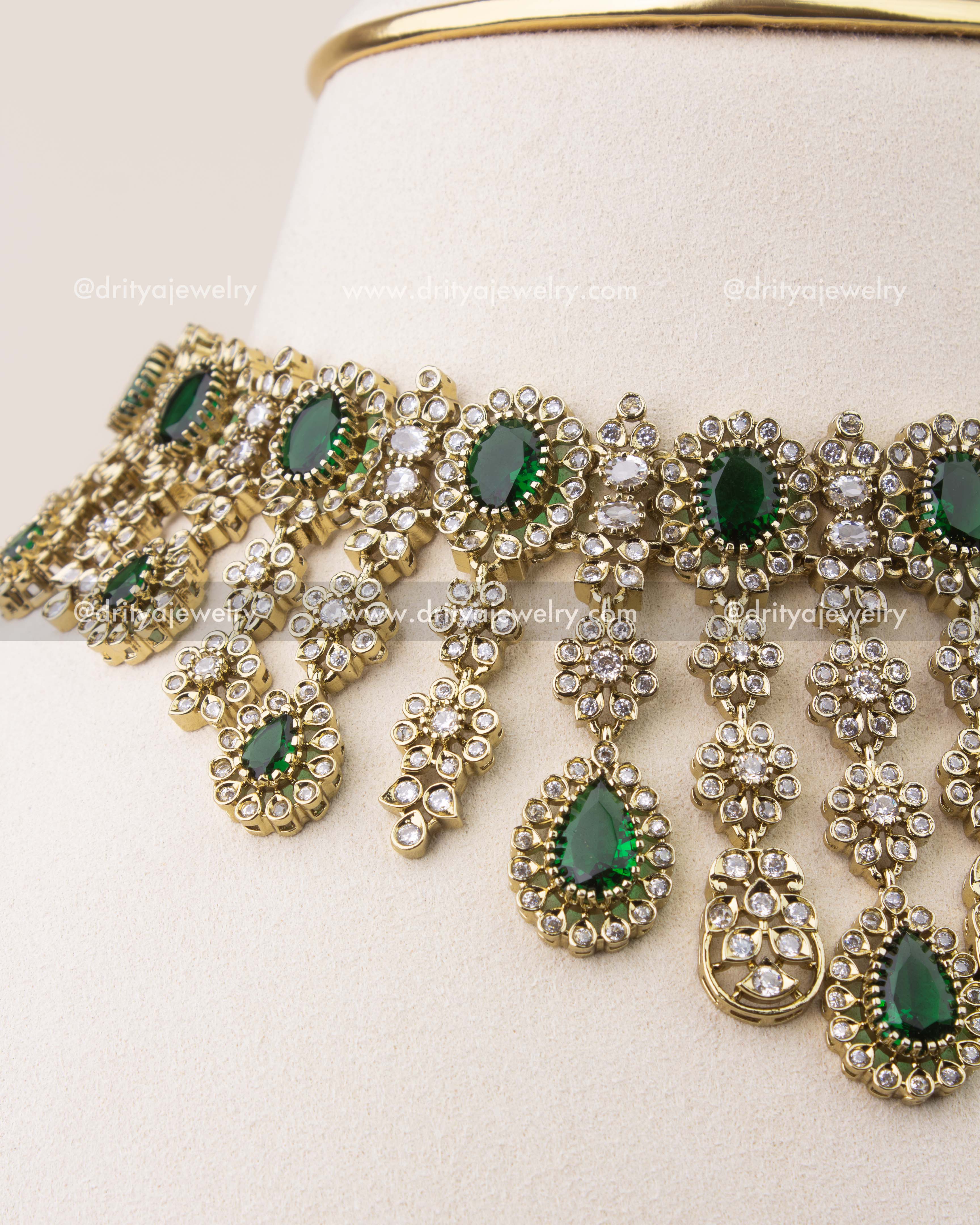 Close-up of emerald green stones and diamond-like CZ work in Victorian necklace