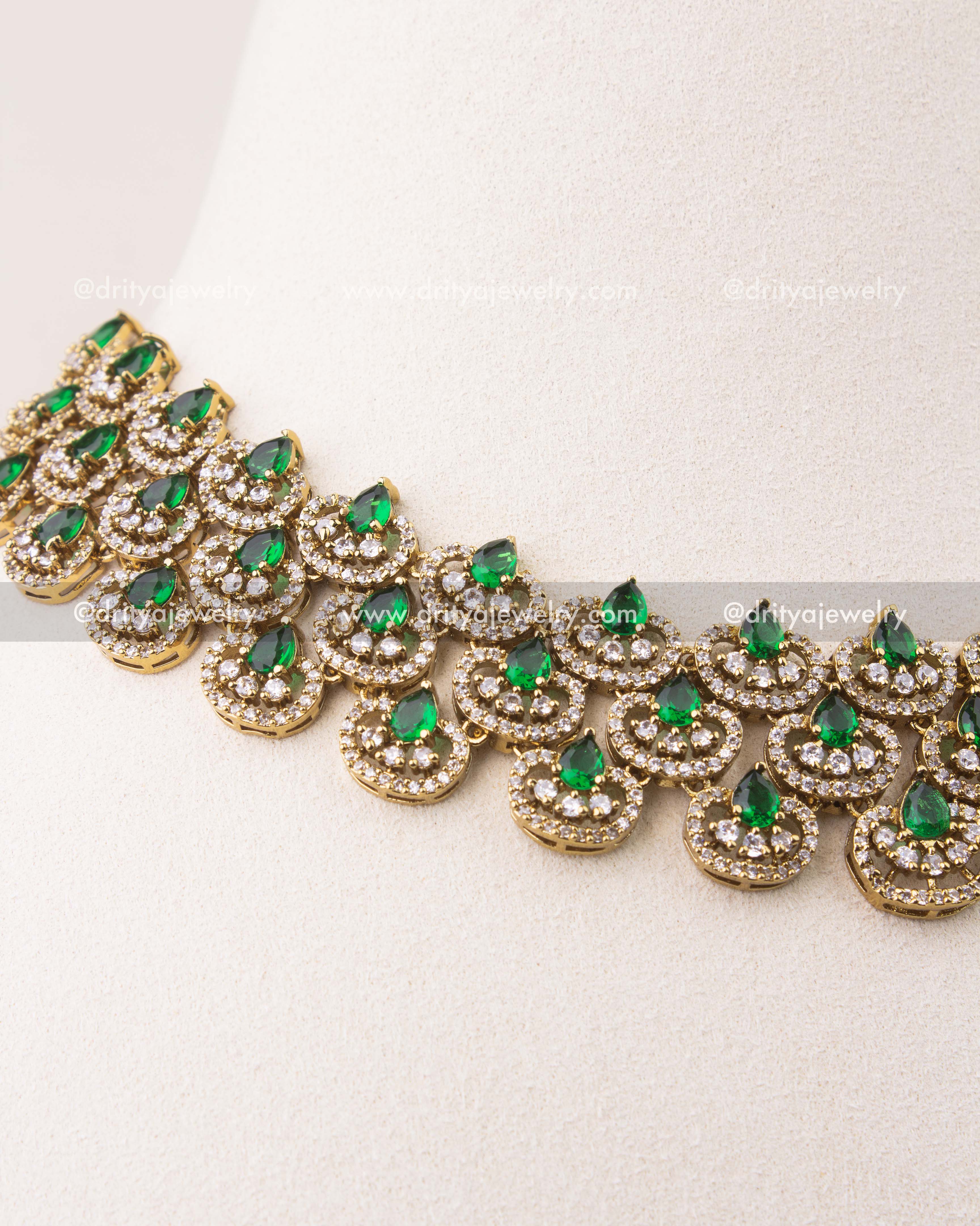 Close-up of Victorian short necklace featuring emerald green teardrop stones and CZ detailing