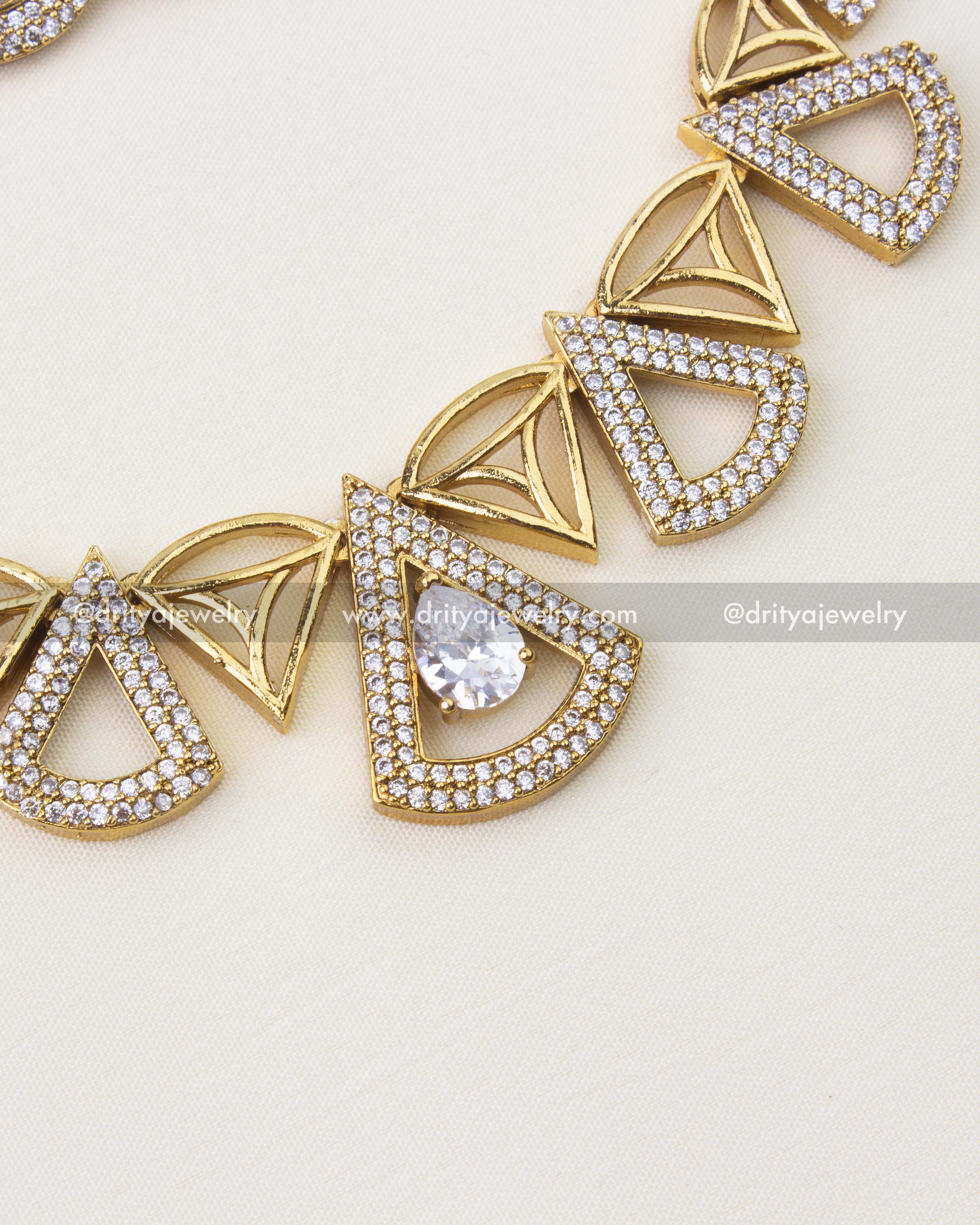 Close-up of geometric CZ stone short necklace with gold finish