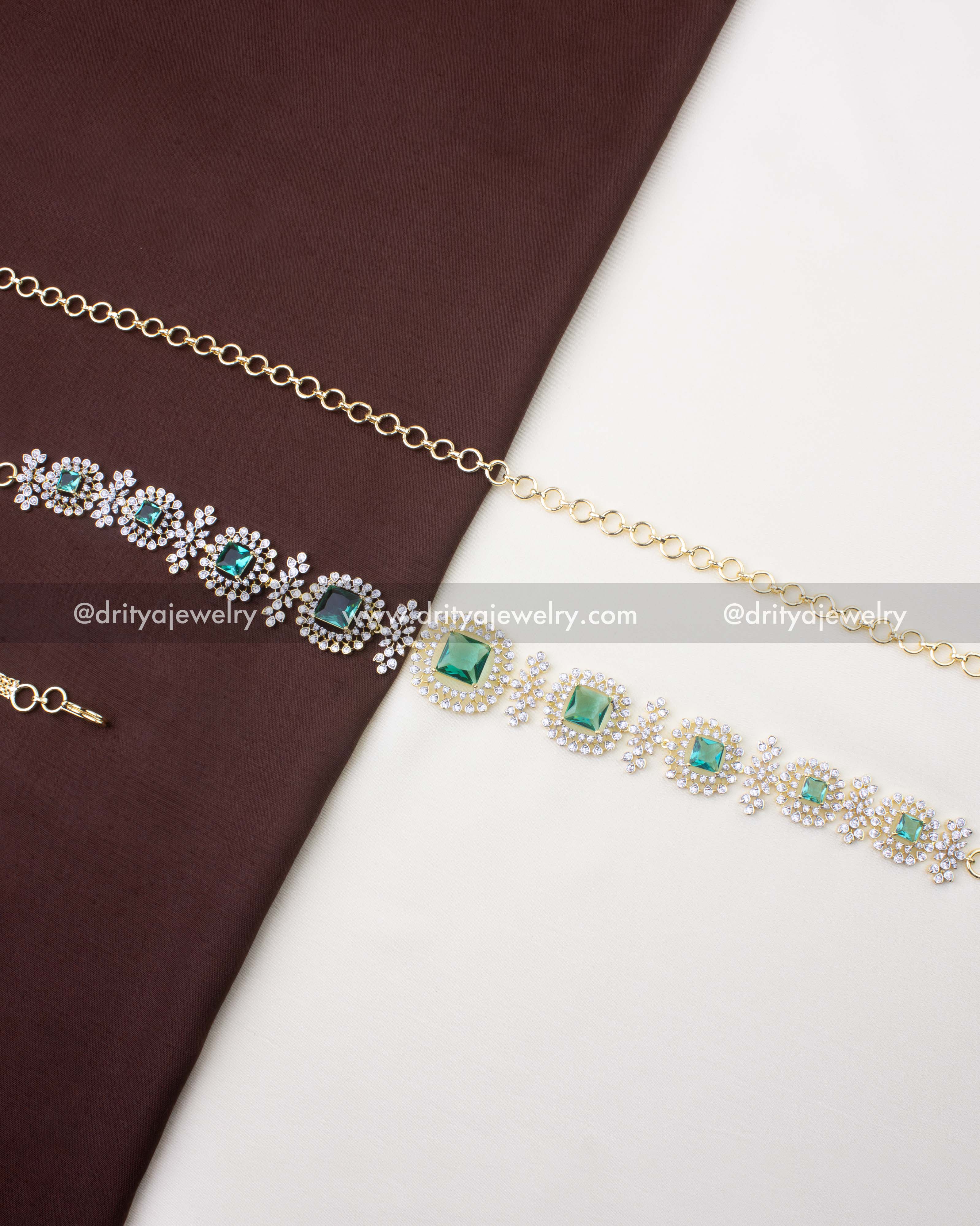 1228-MG premium CZ and Russian emerald waist chain full view on fabric backdrop