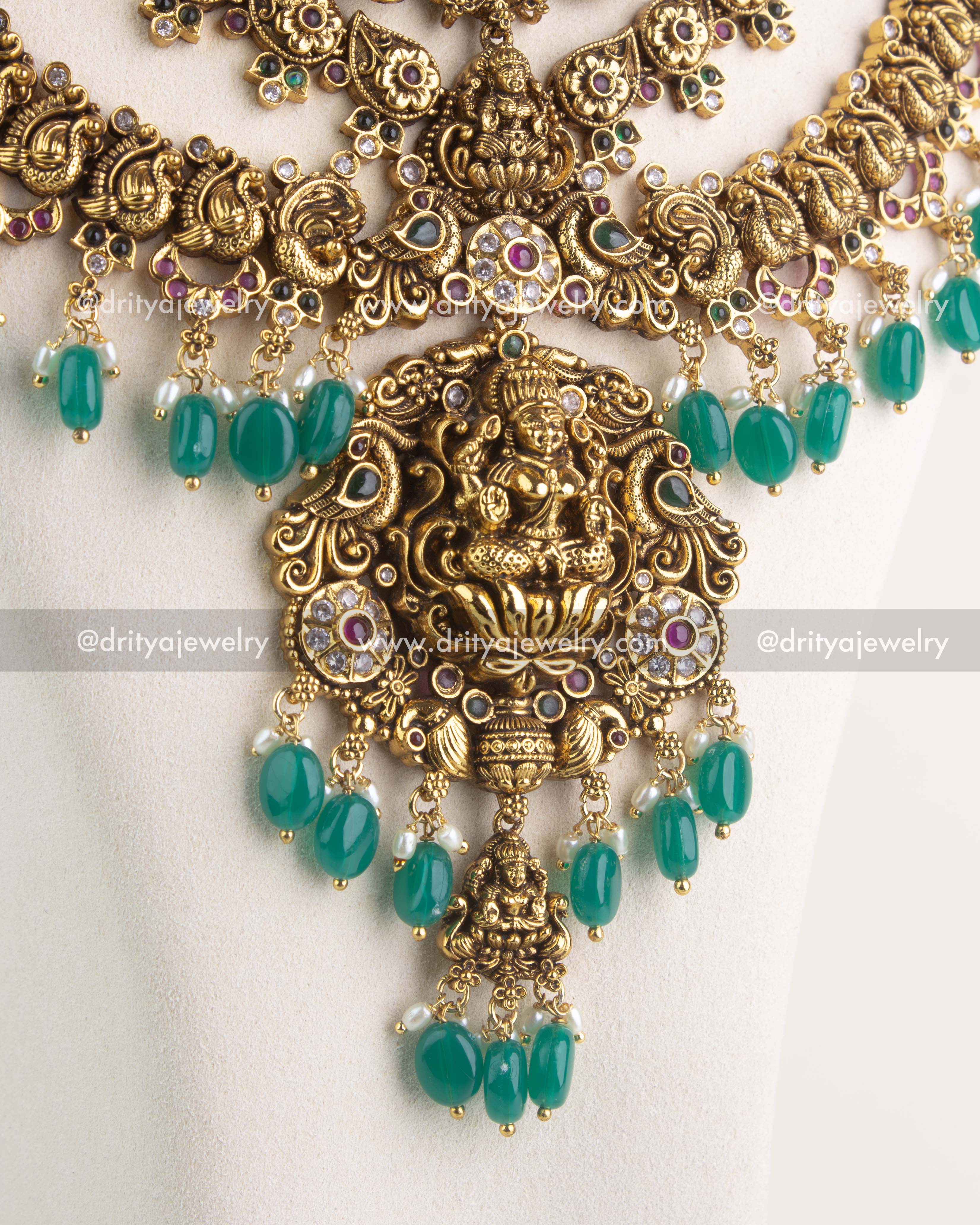 SKU 1164 Necklace Set close-up of central god idol pendant with green beads and stone-studded detailing.