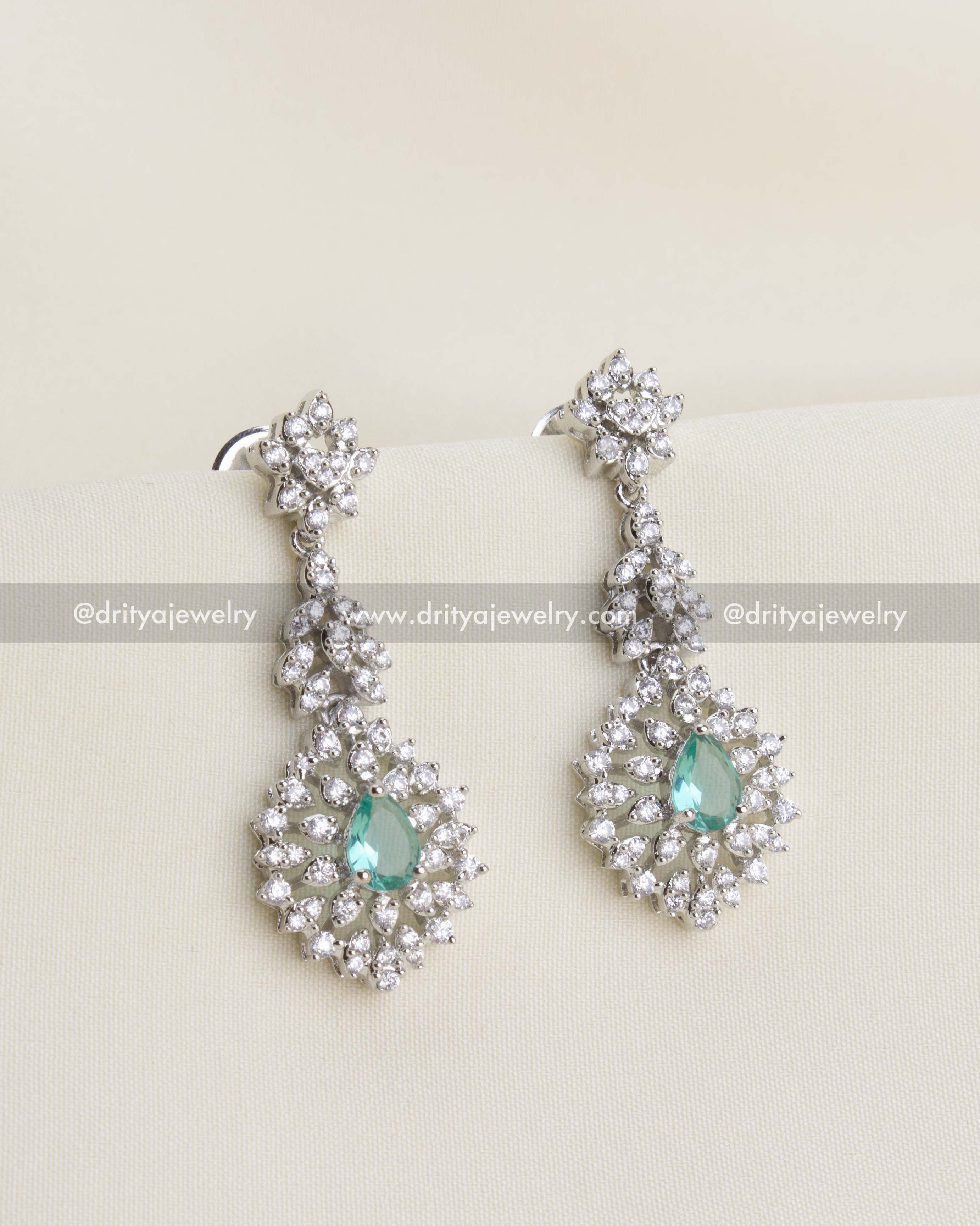 SKU 1136 Necklace Set - Close-up front view of long zircon and emerald-tone earrings