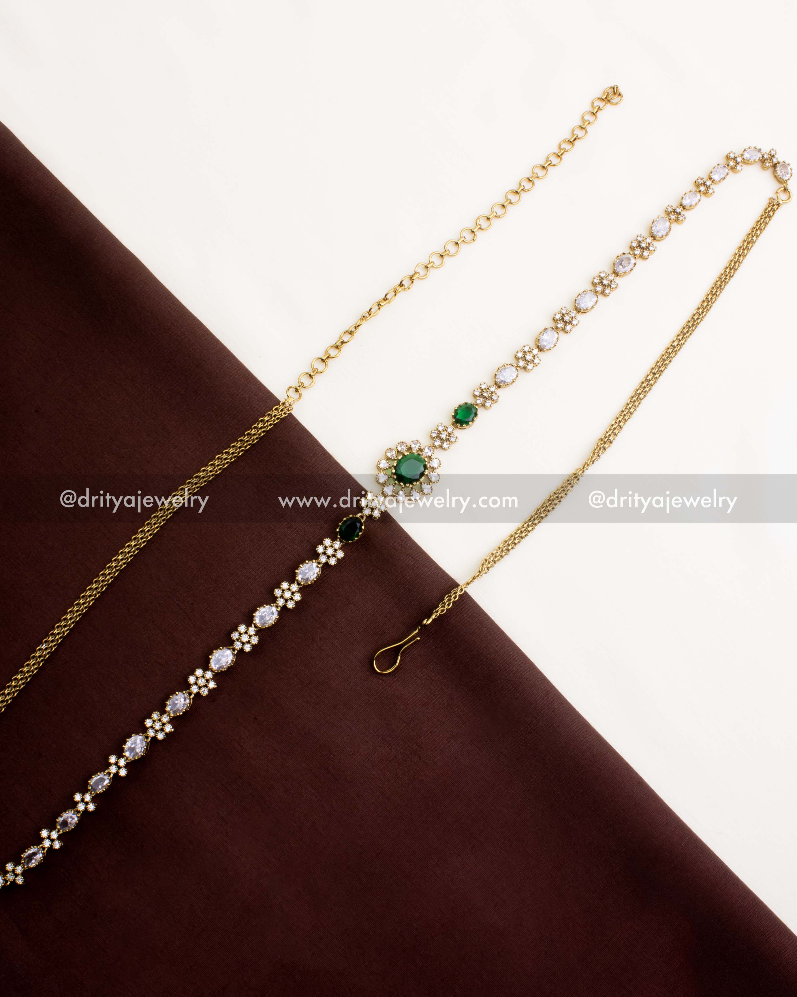 1109-G Victorian emerald CZ hip chain full length view on fabric backdrop