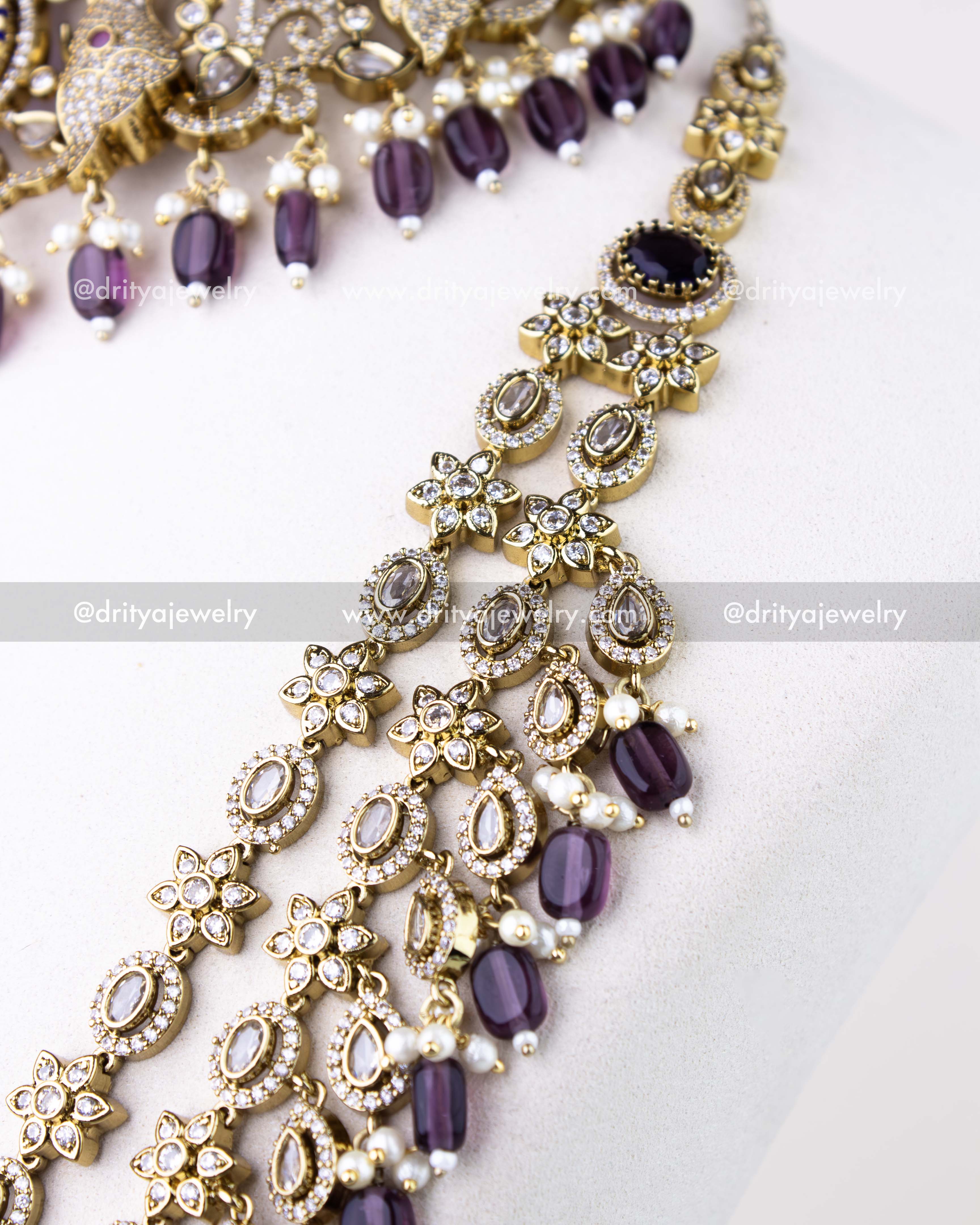 1309-PUSET angled view of layered necklace links showing floral and teardrop CZ work