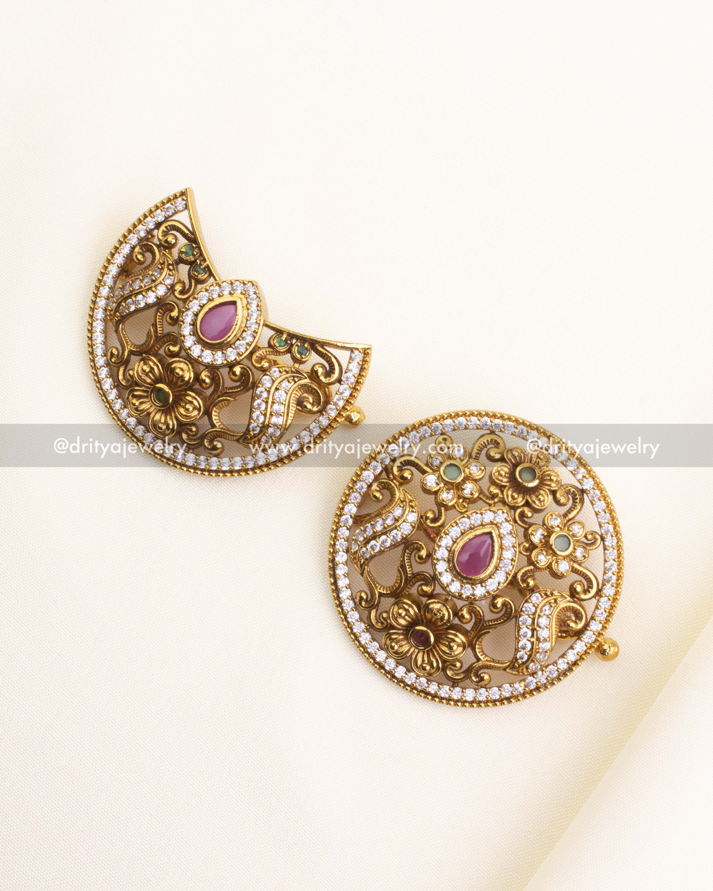 Full view of antique finish sun and crescent moon hair pins placed on ivory background.