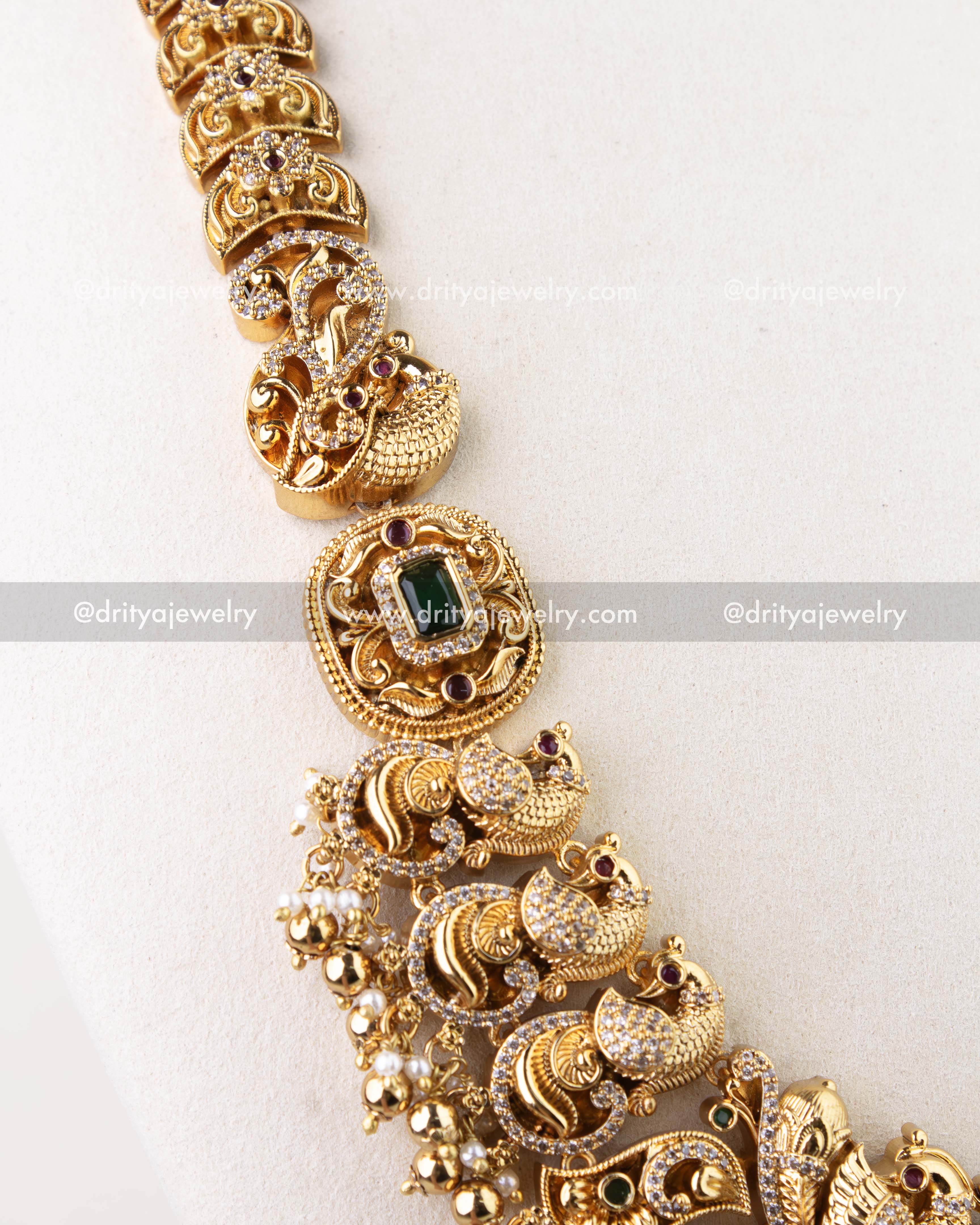 1310 - Detailed view of side motifs and green stone element on antique gold long haram