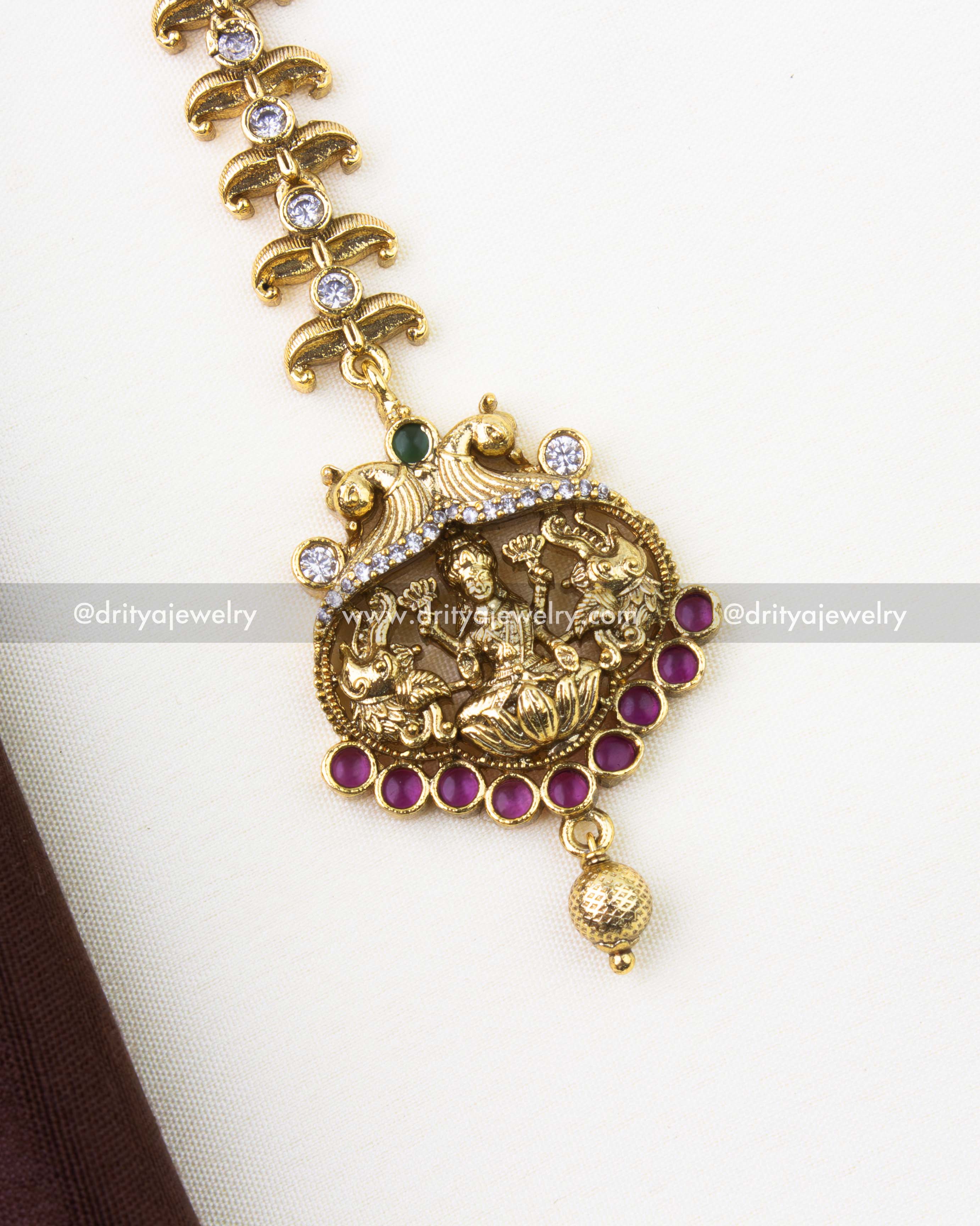 SKU 1286 close-up of god idol pendant and ruby stones on maang tikka