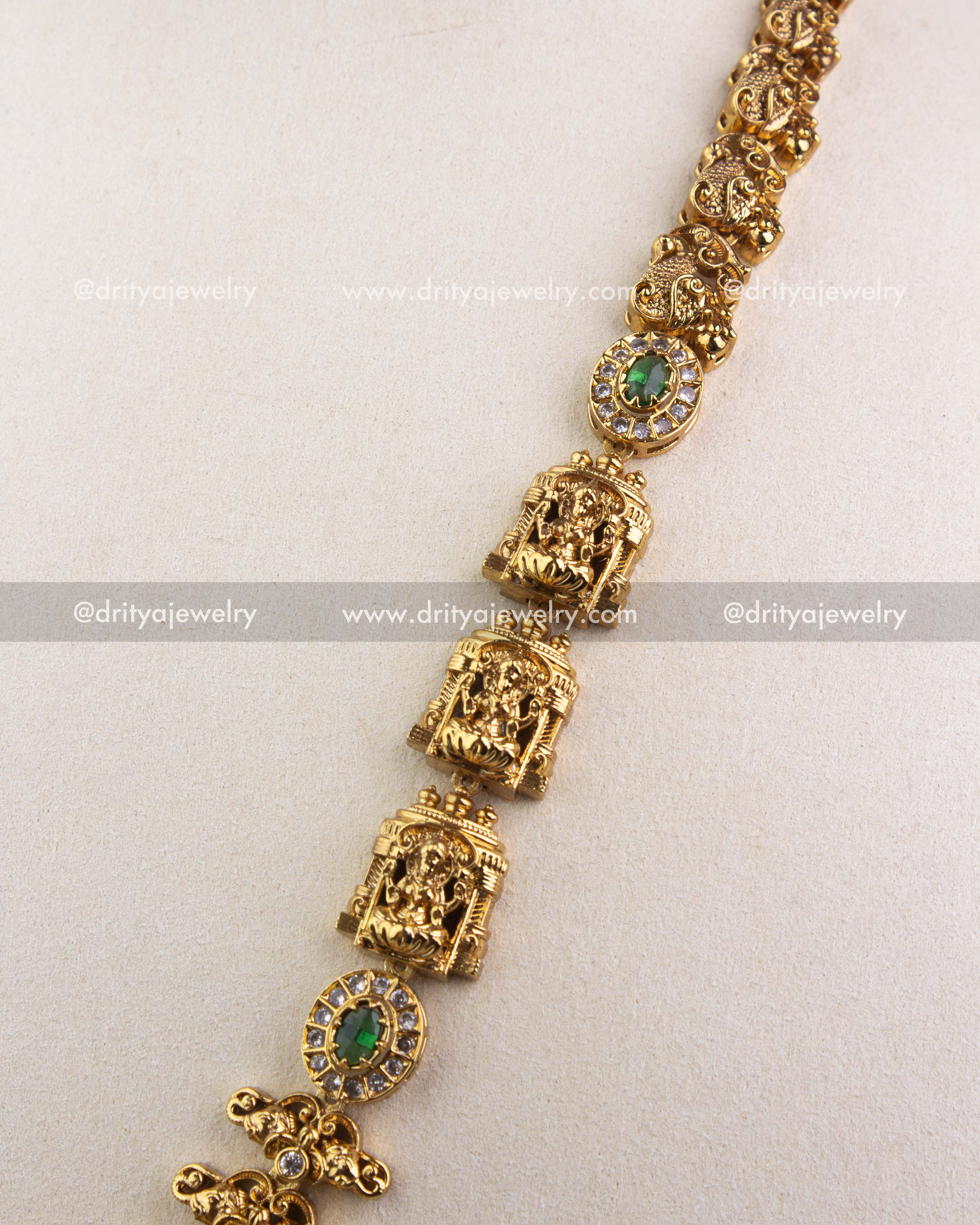 1240-G side view of temple long necklace showing repeating deity panels and green stone settings