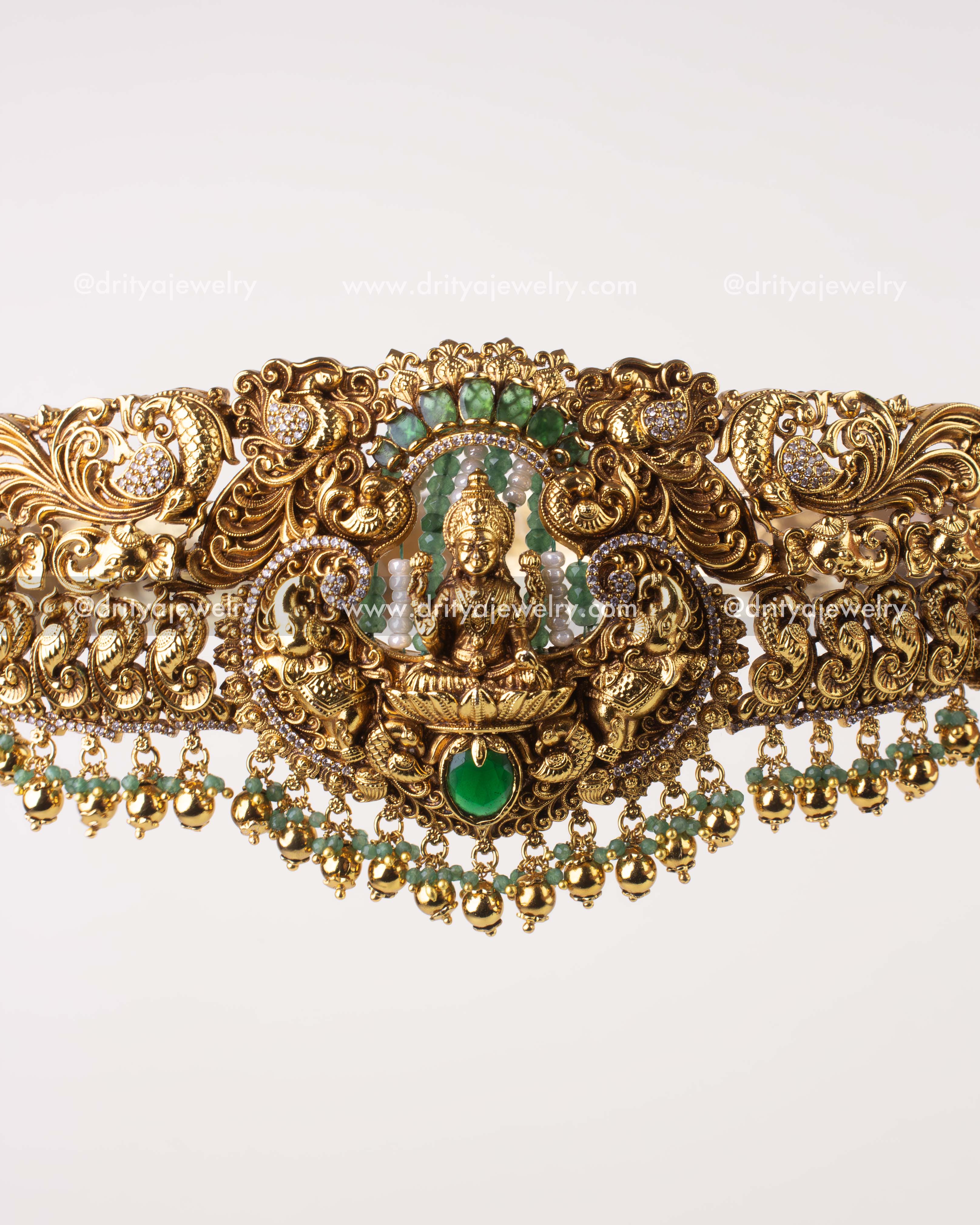 1244-WB close-up of central Lakshmi deity with emerald green cushion stone on waist belt