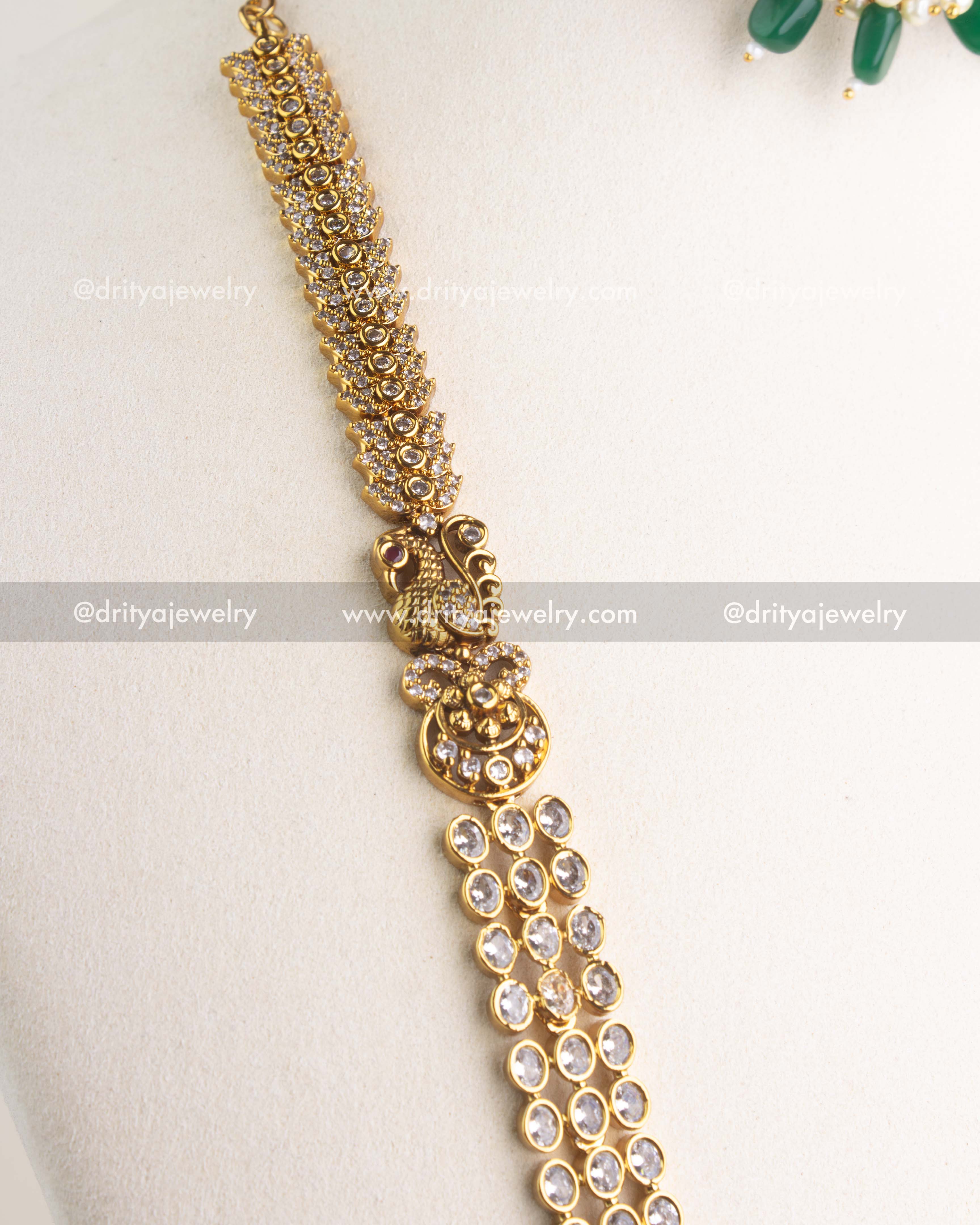 SKU 1161 Necklace Set detailed view of antique gold peacock motif and linked stone-studded chain
