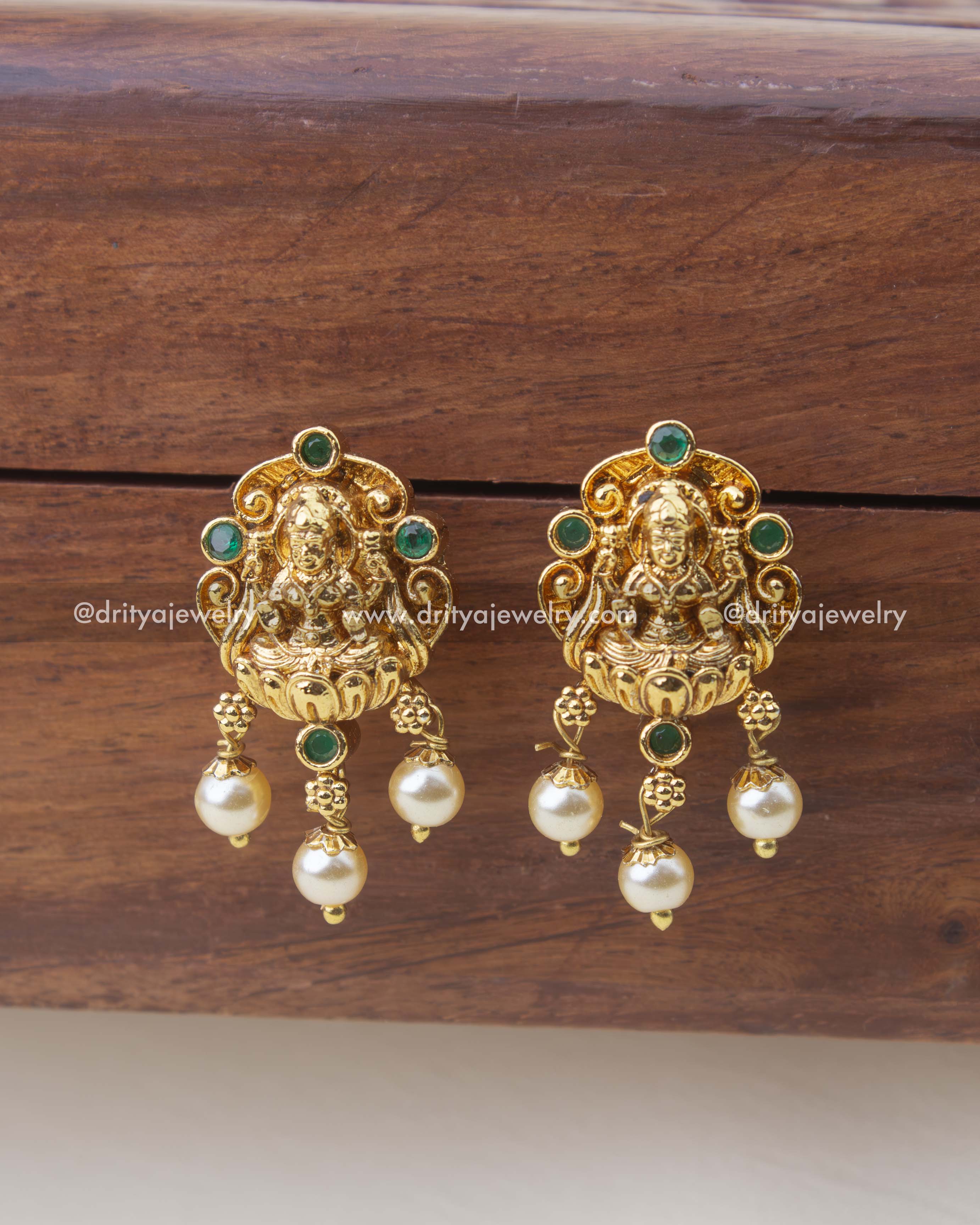 1303-G temple god idol stud earrings with emerald stones and pearl drops front view