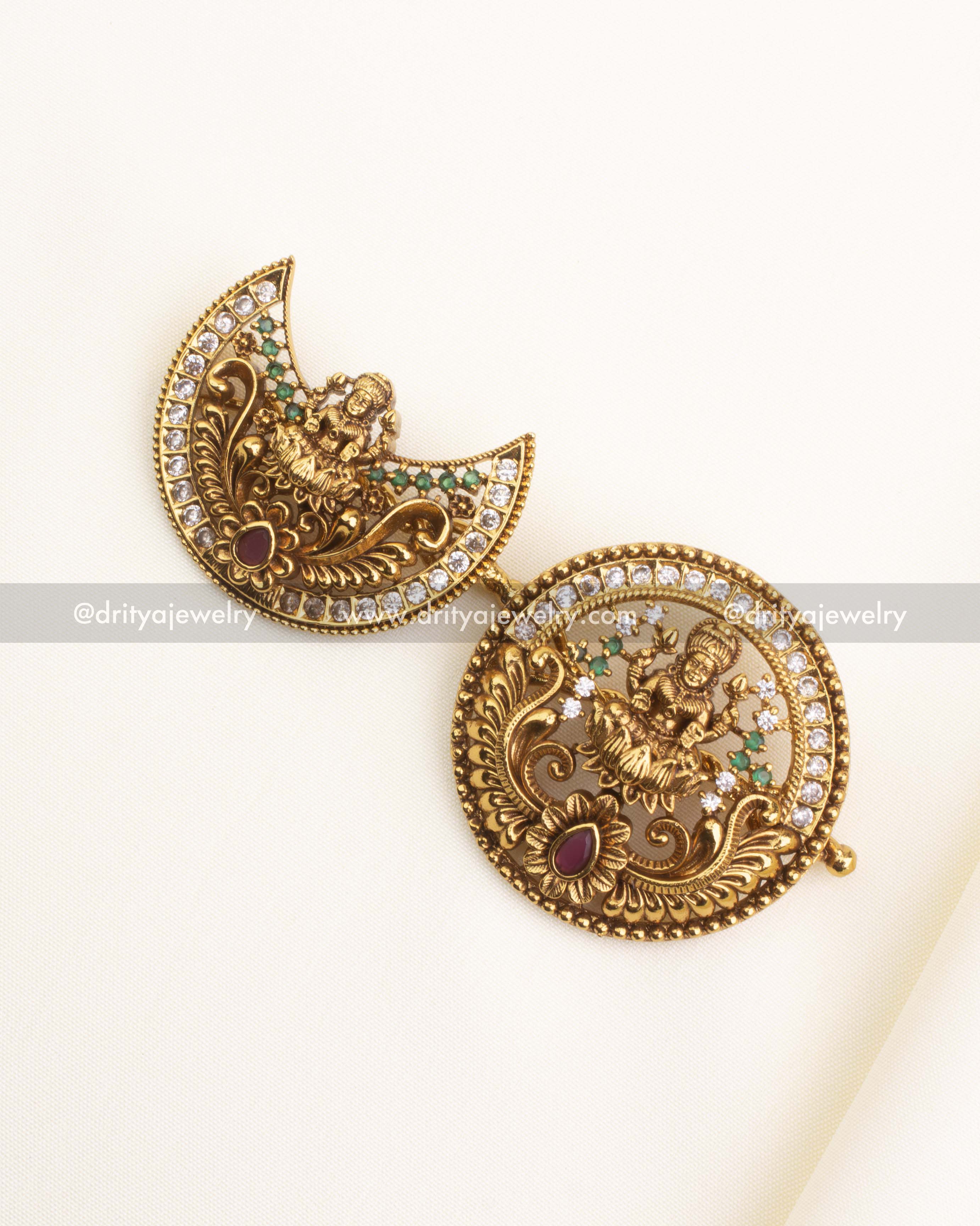 1172 - Full view of matching antique sun and moon temple hair pins on fabric background