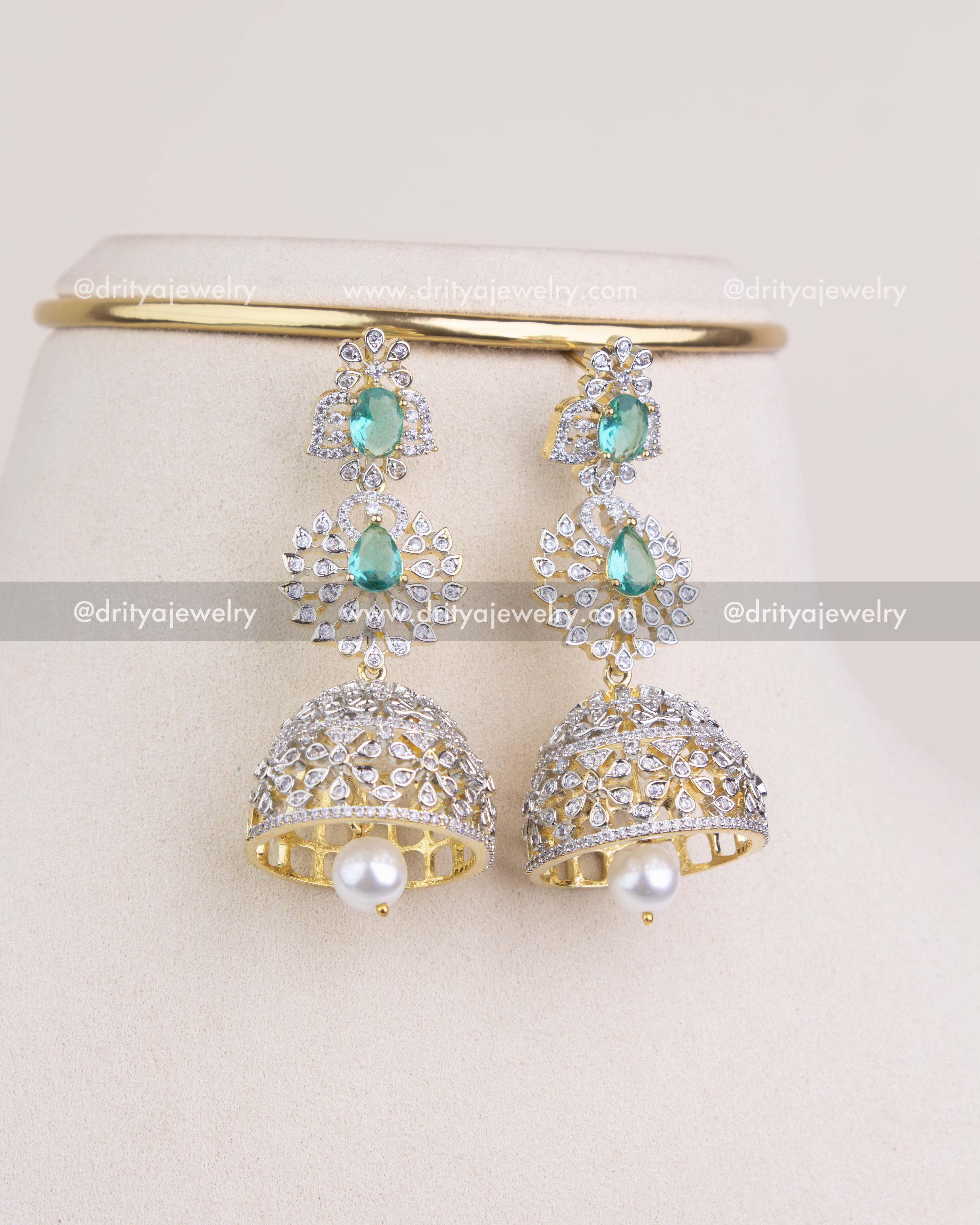 1227 - Close-up of big CZ and emerald toned jhumka earrings