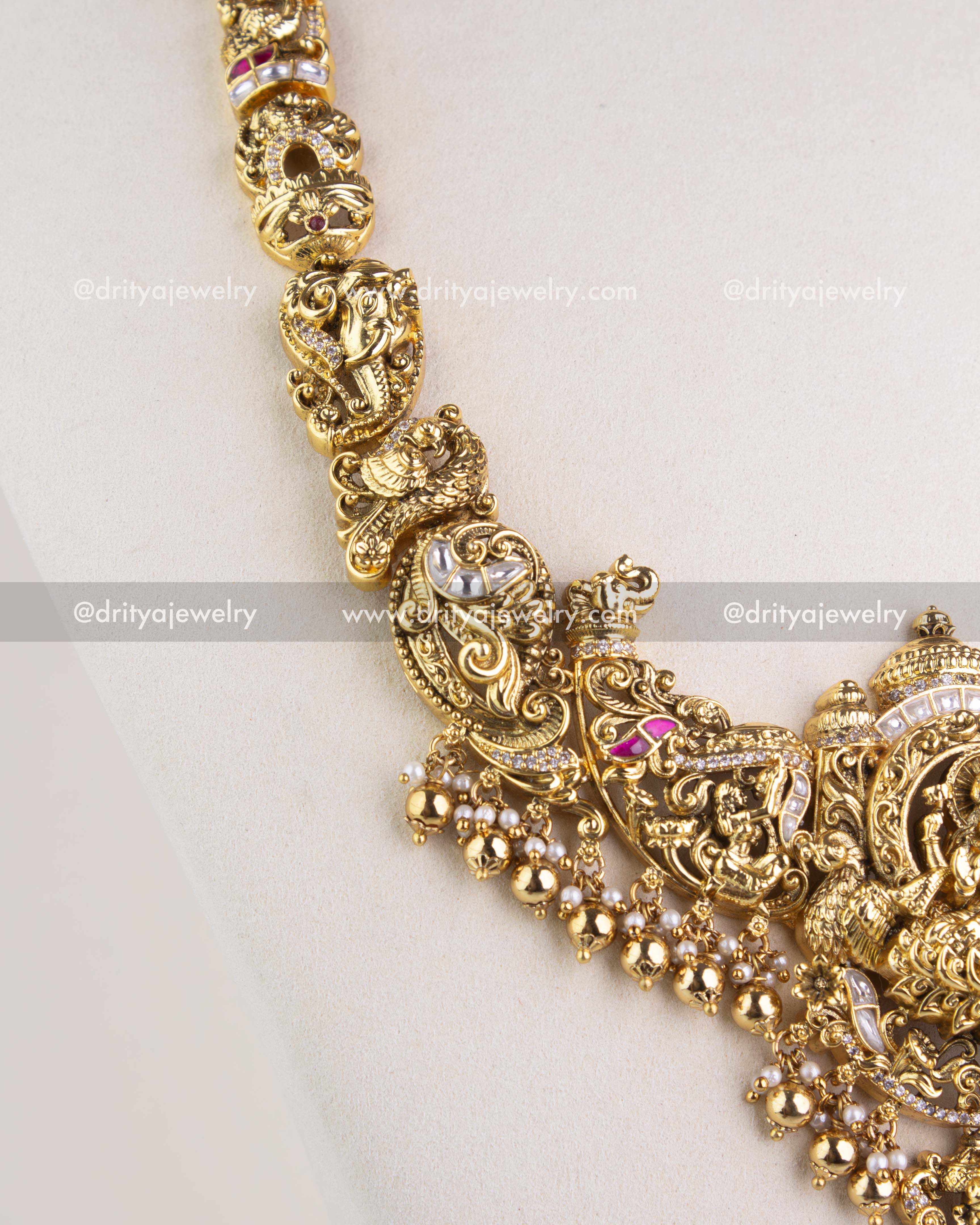 1238 - Close-up of sculpted motifs and bead fringe on temple necklace