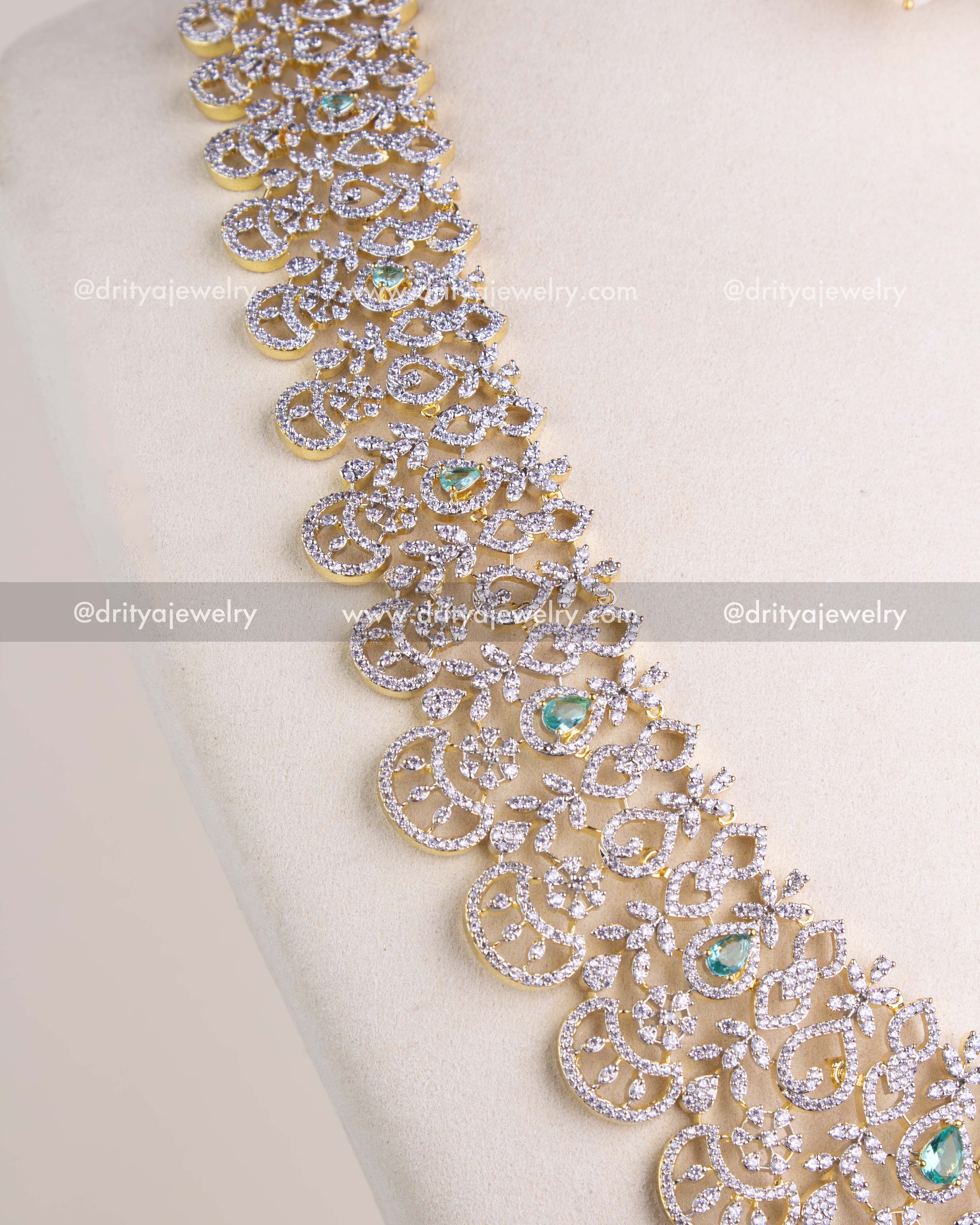 1208-RE close view of long CZ necklace with emerald accents and scalloped pattern