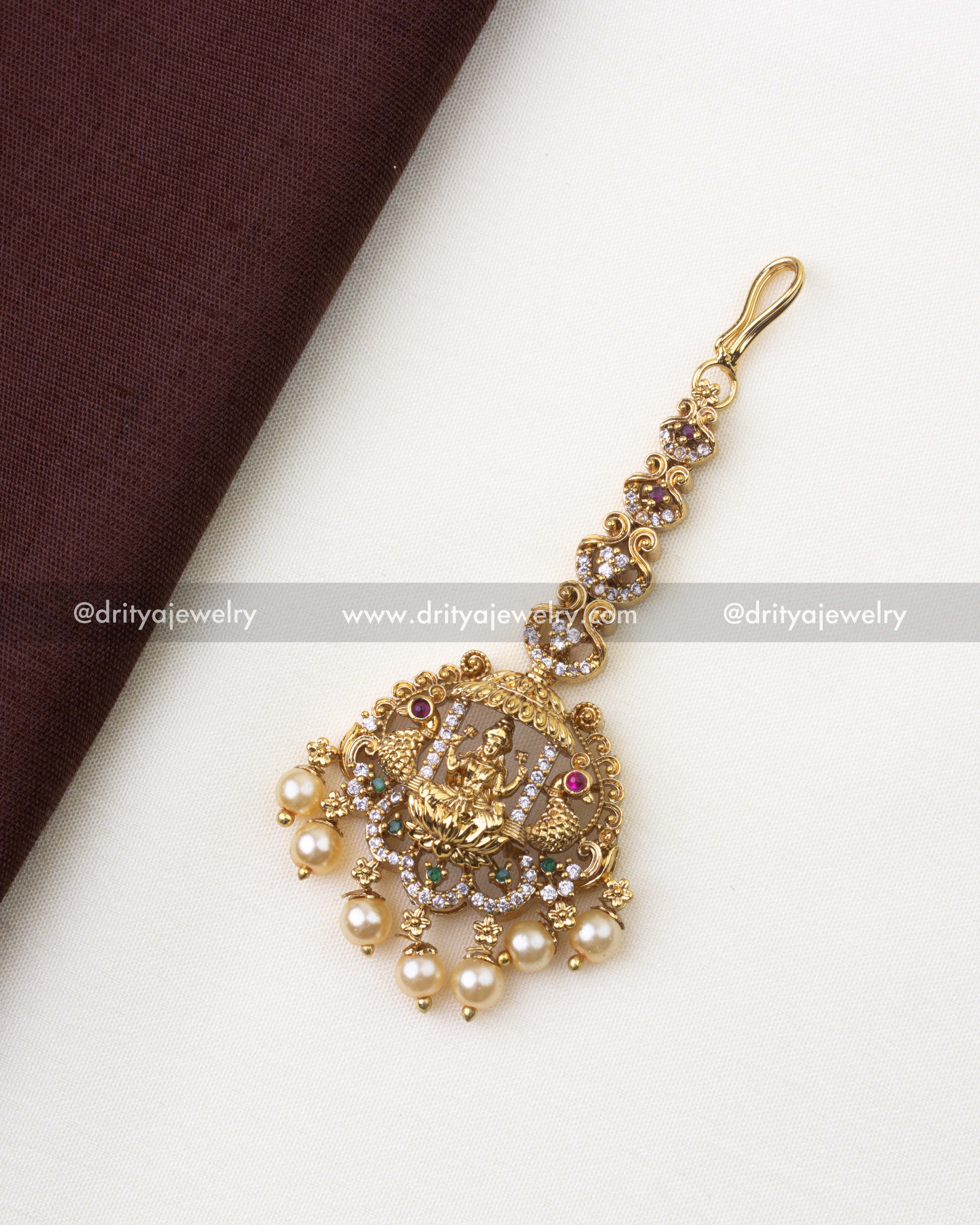 SKU 1217 full view of traditional temple maang tikka with pearls on fabric background