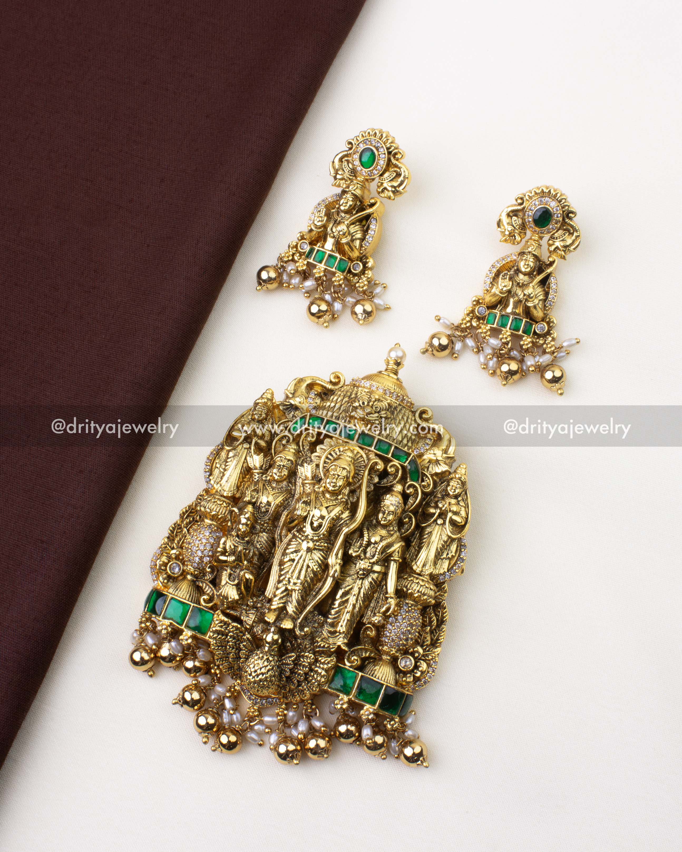 SKU 1221 Ram Parivar pendant with matching earrings laid on fabric