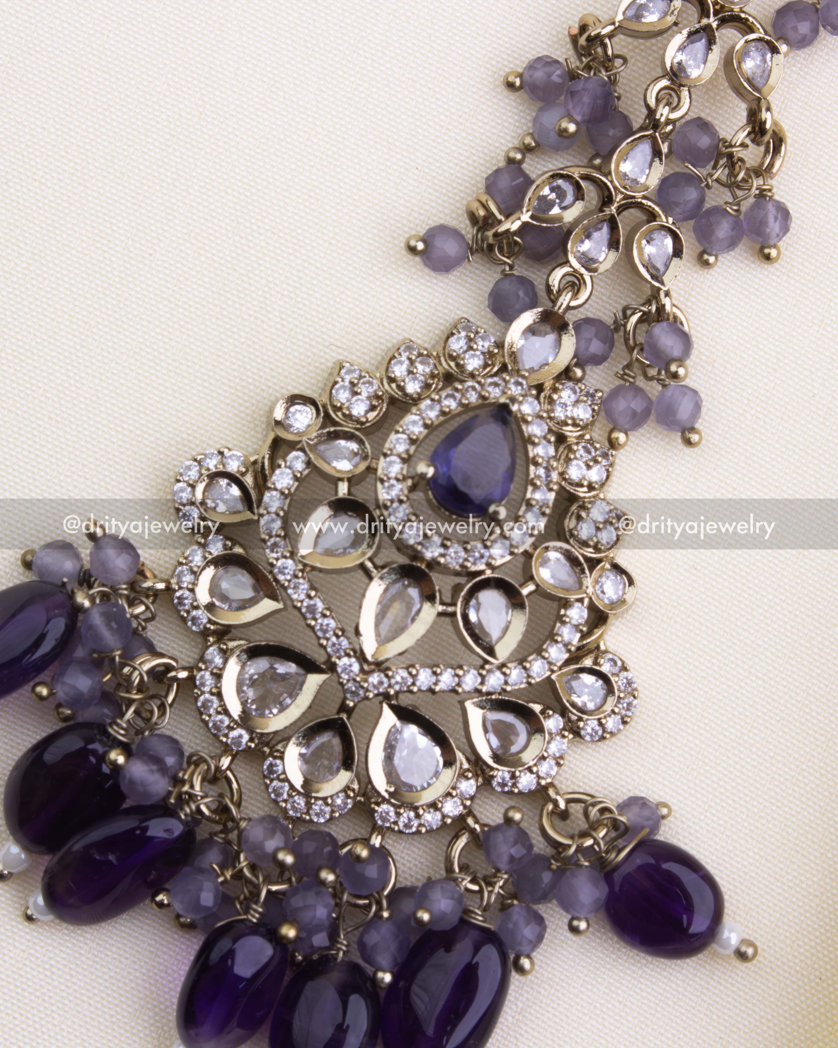 Close-up of purple stone bridal maang tikka with gold-toned finish and bead hangings, SKU 1133-PU