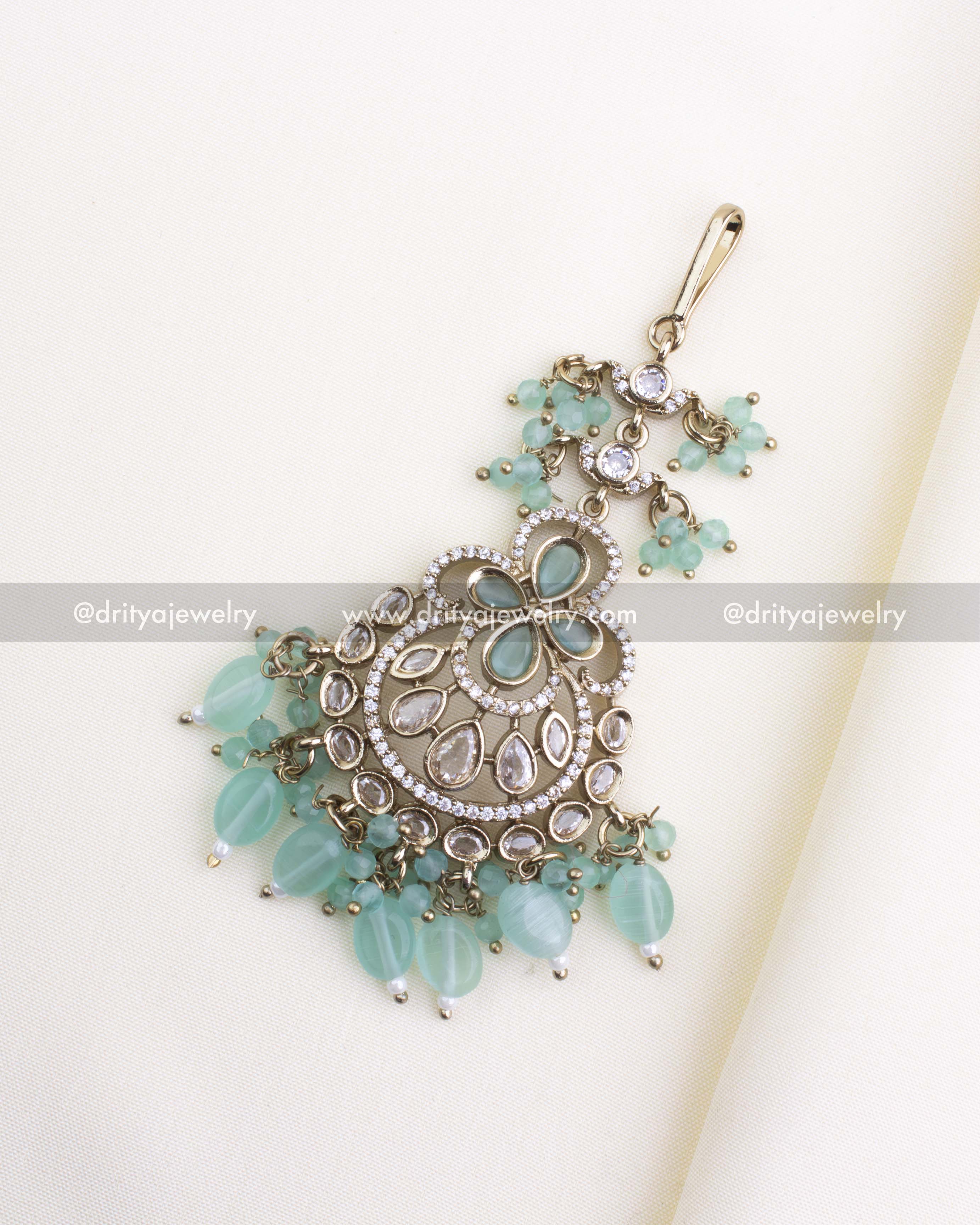 610-MG Victorian maang tikka with mint green beads, full front view on fabric background