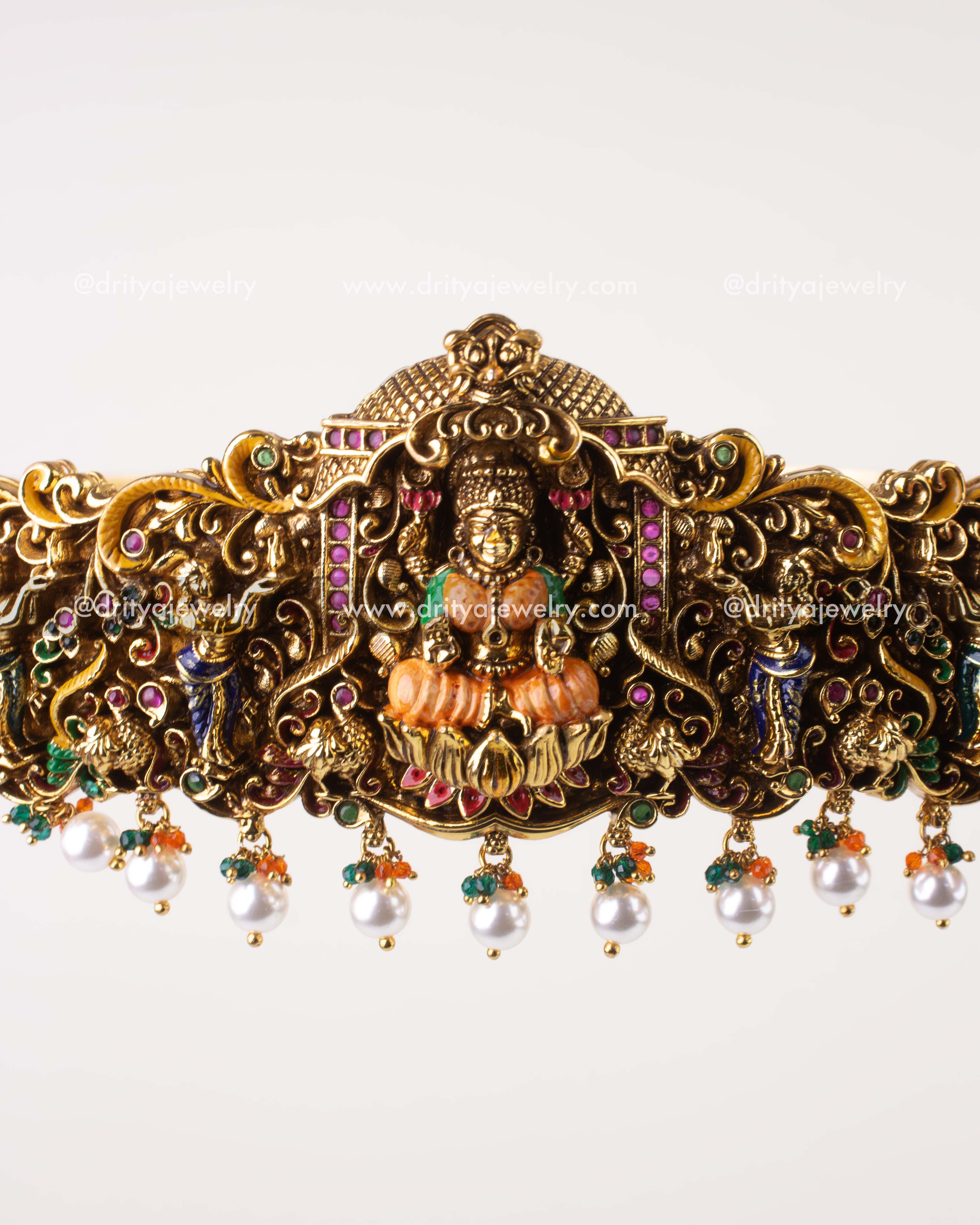 Front close-up of Lakshmi Devi idol centerpiece on meenakari waist belt