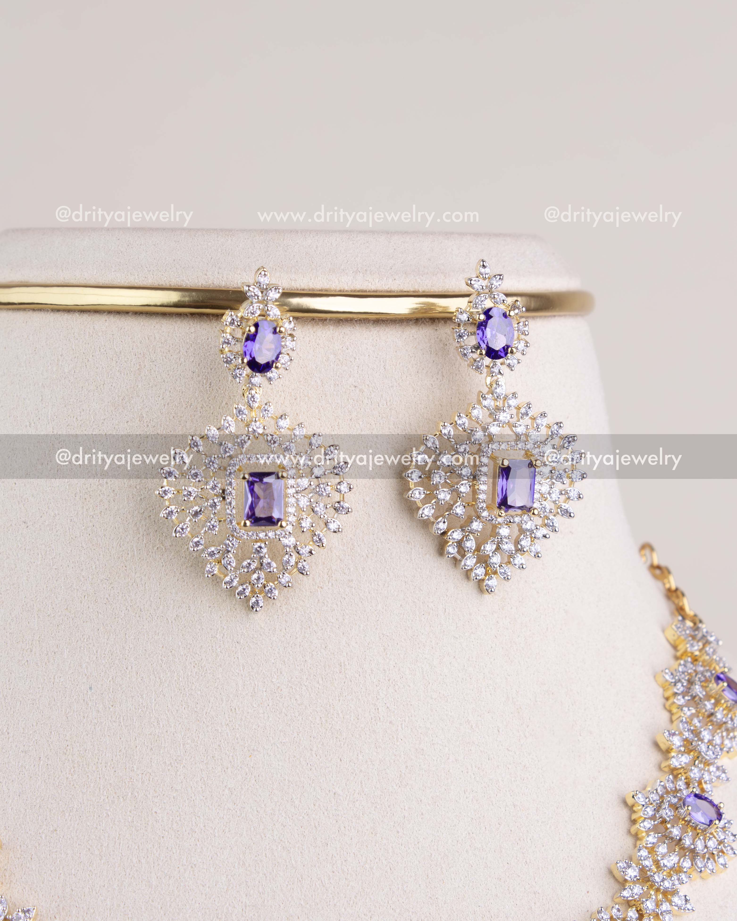 1210-PU earrings close-up showing purple stones and CZ-studded design