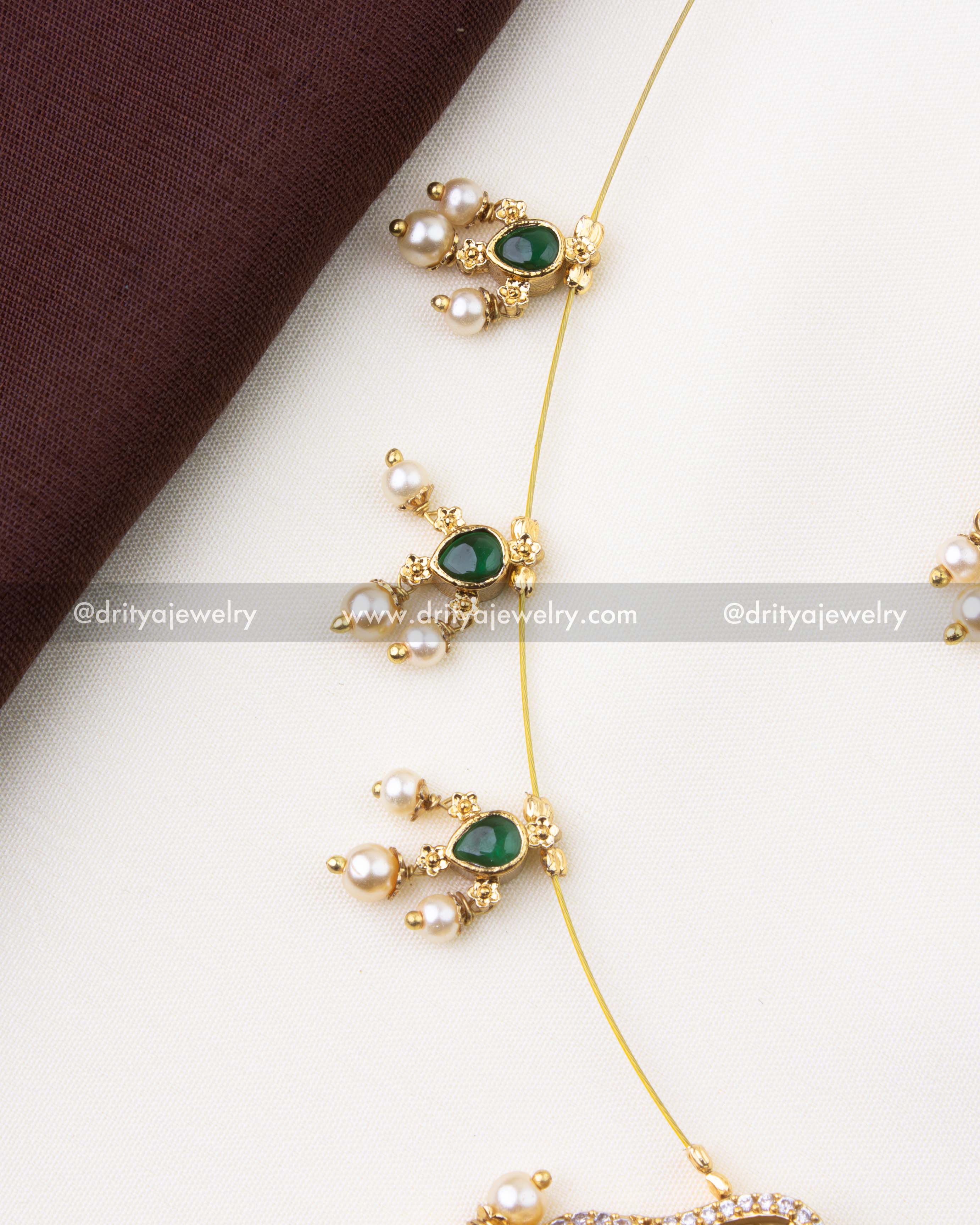 1216-G invisible chain necklace side view showing emerald green and pearl drop motifs