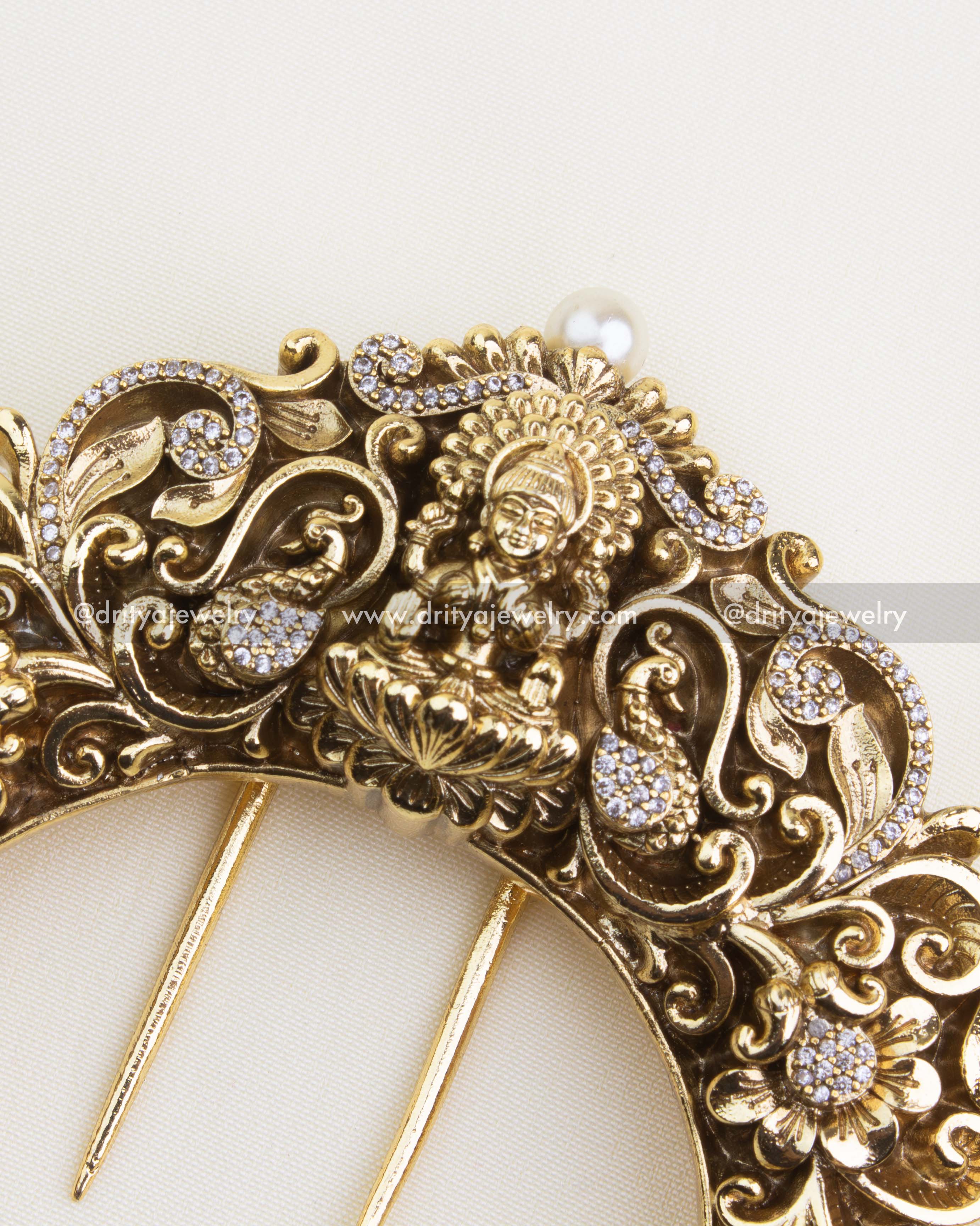1141 - Hair Pin - Close-up view of antique gold god idol nakshi hair brooch with stone detailing