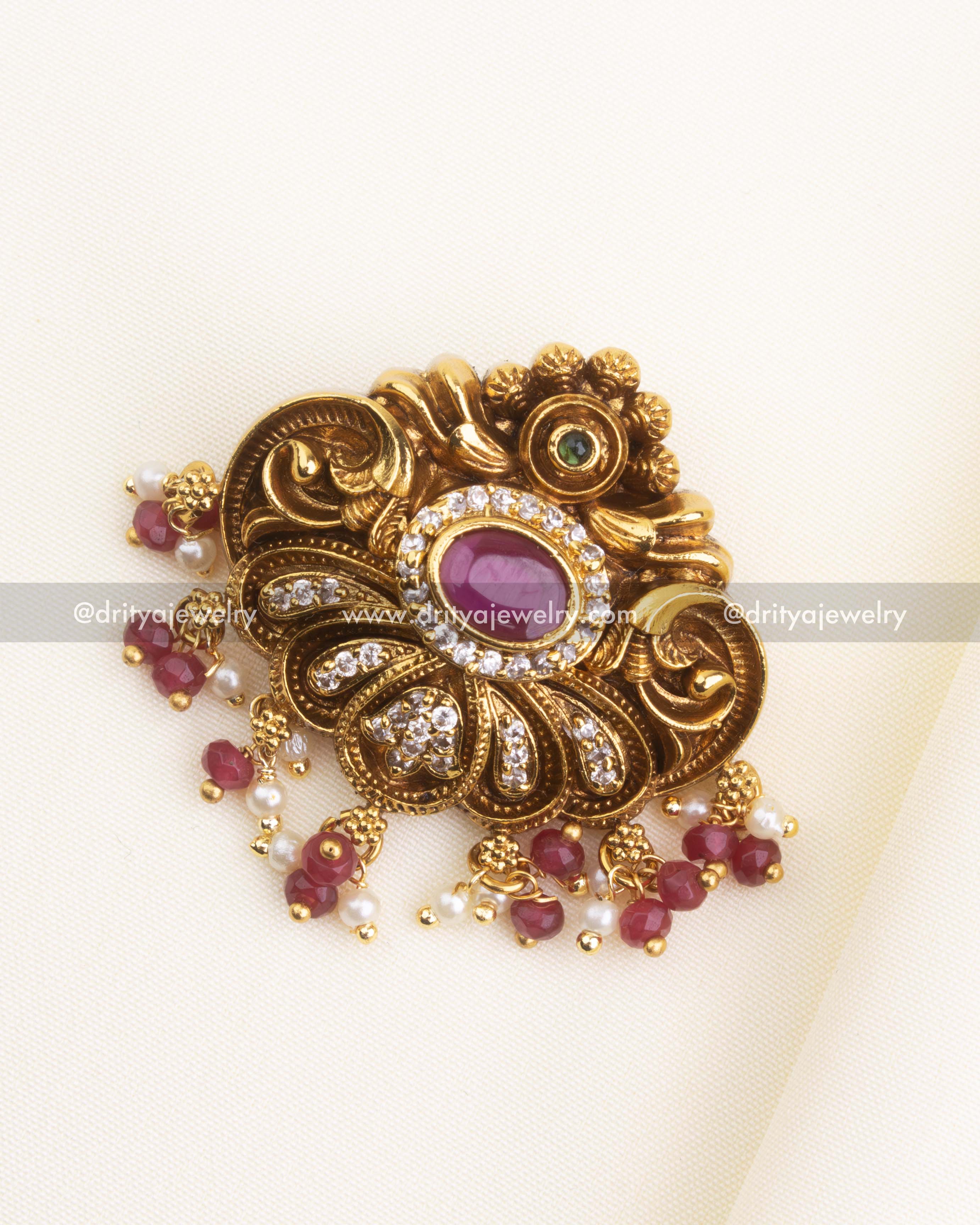 SKU 1174 antique gold-tone pendant with ruby stone center and ruby bead drops front view