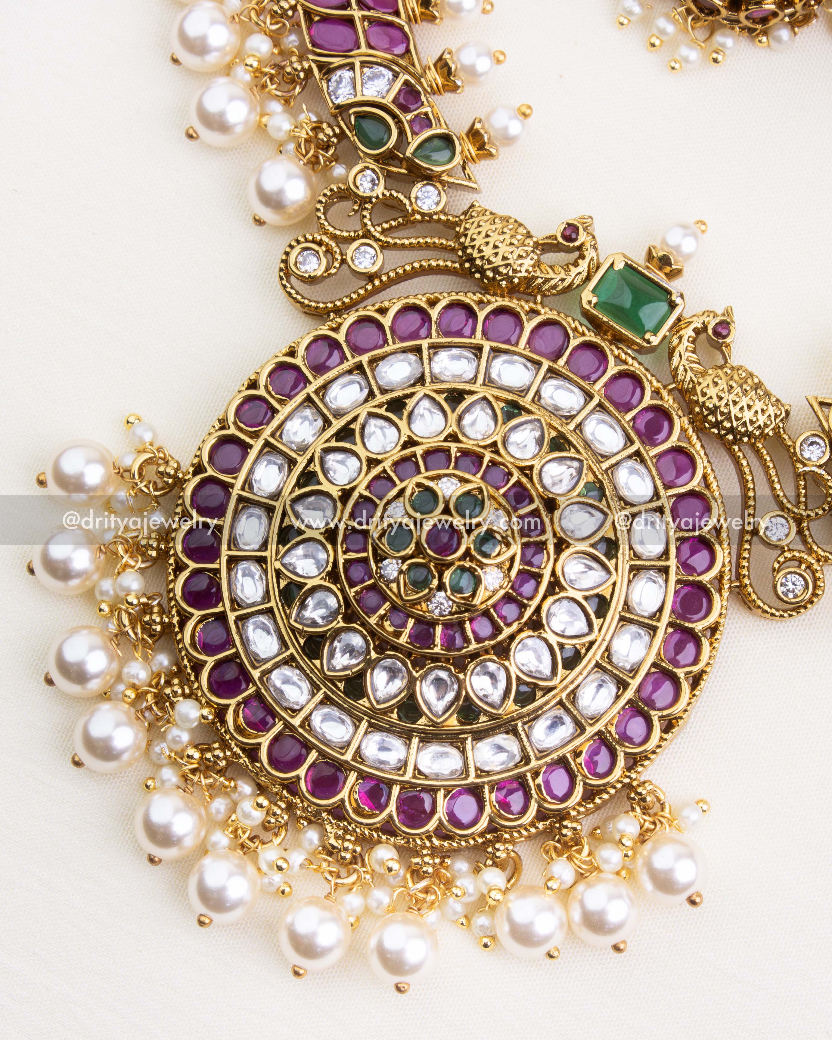 1248 - Close-up of circular pendant with peacock motifs and pearl drops