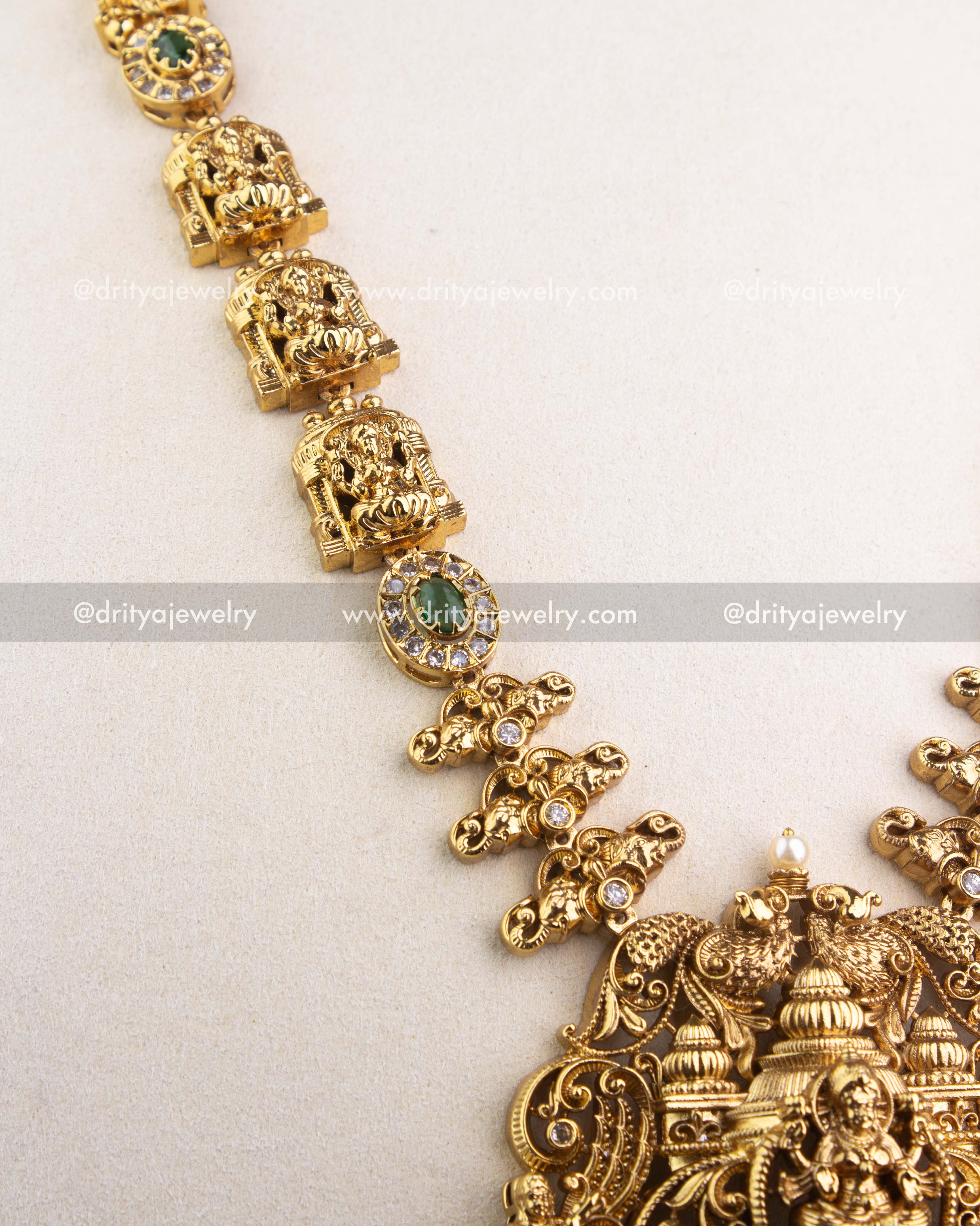 1240-G detailed view of deity motif links and green stone accents along the long necklace chain