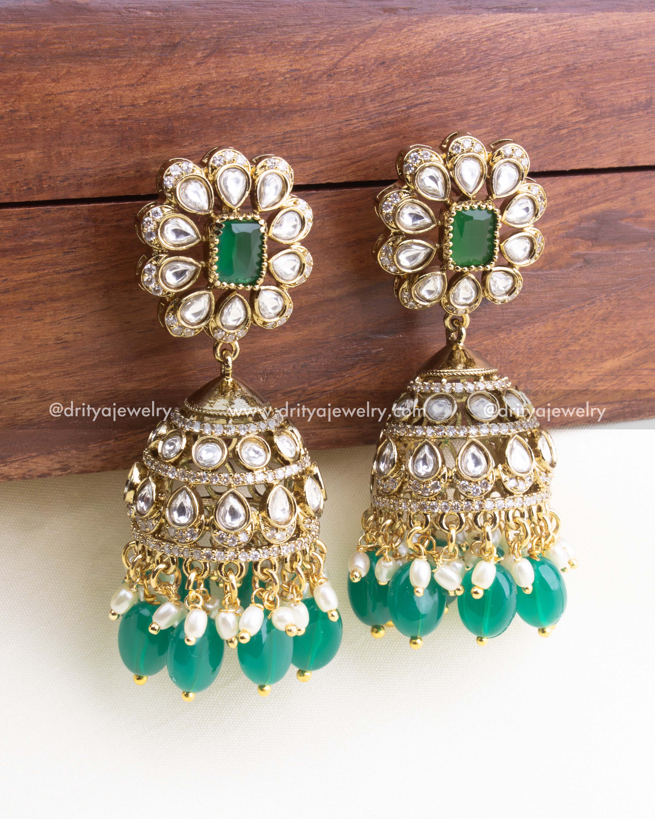 1157 Necklace Set close-up of kundan jhumka earrings with emerald green and pearl-like drops