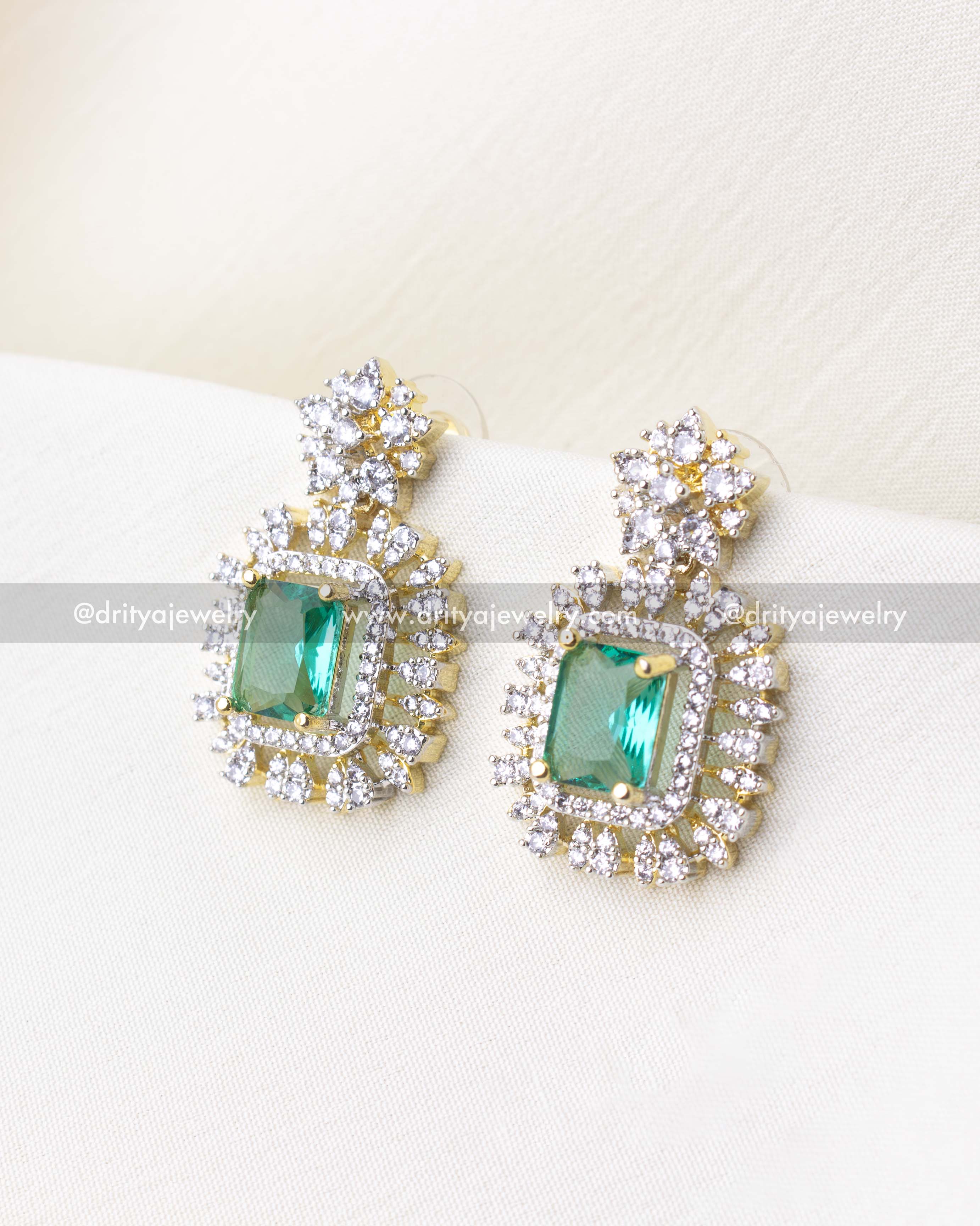 1276-RE emerald centre stone earrings close-up front view