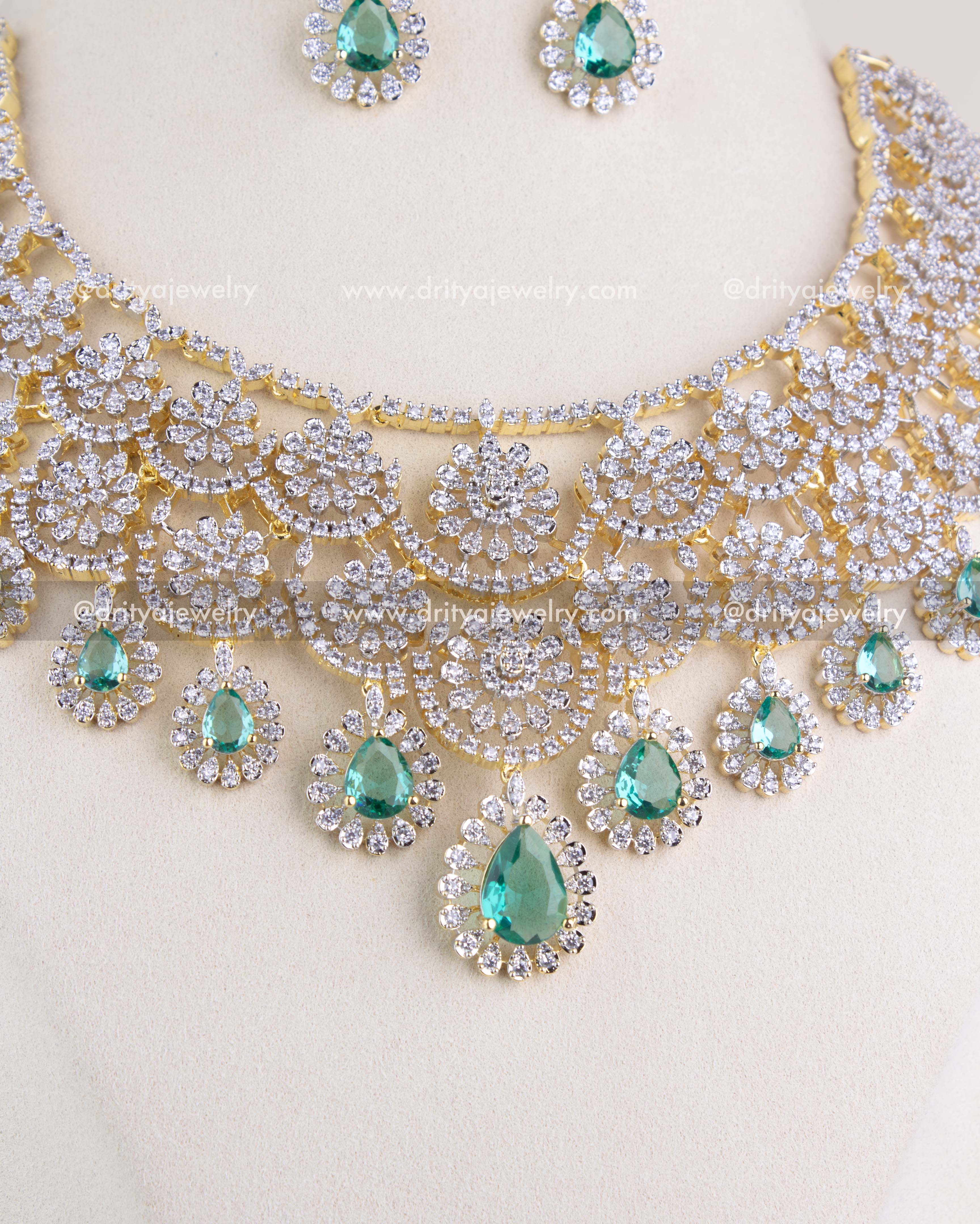 1209-RE close view of emerald teardrop center pendant and halo CZ work