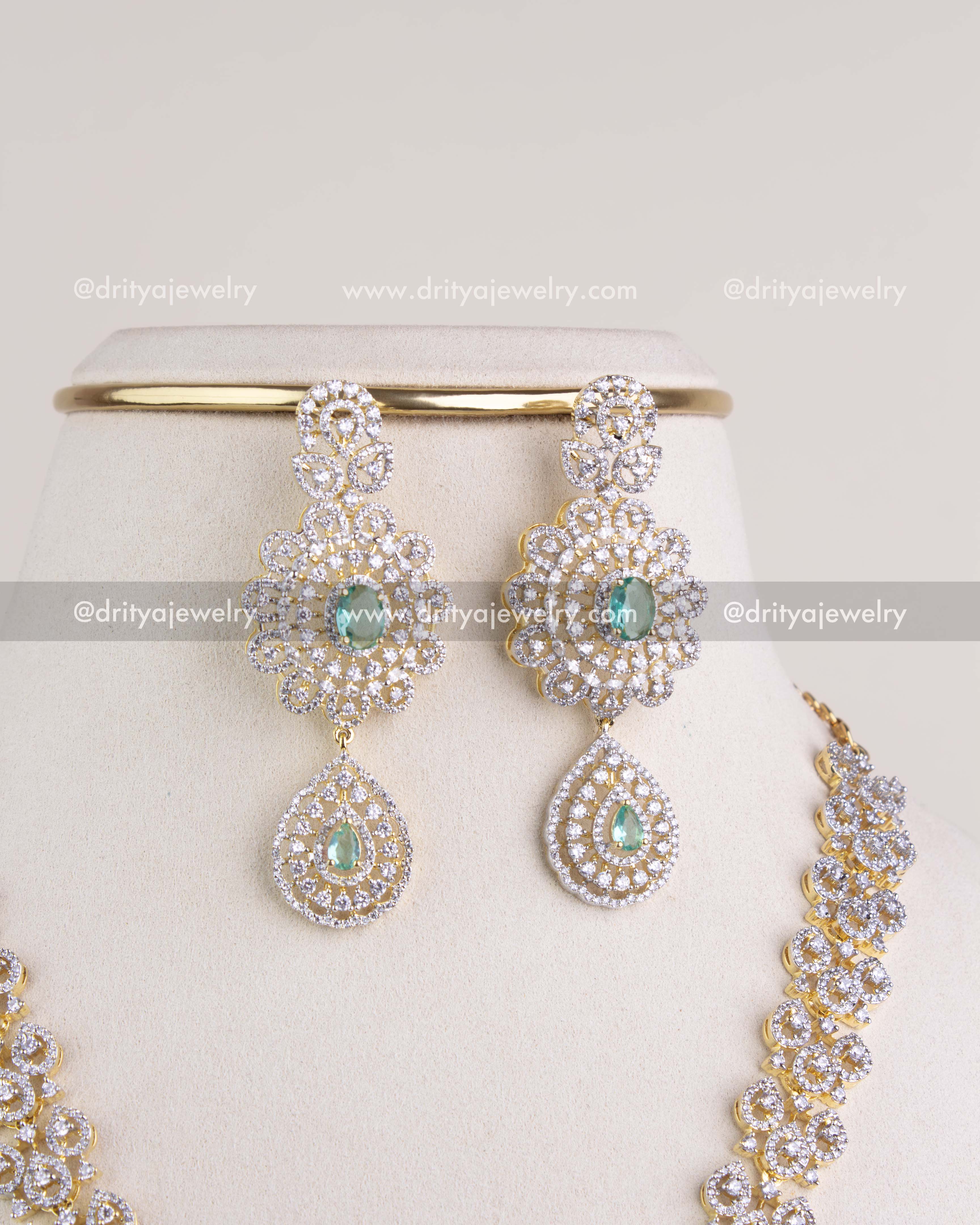 1229-RE matching CZ and emerald-tone dangler earrings close-up