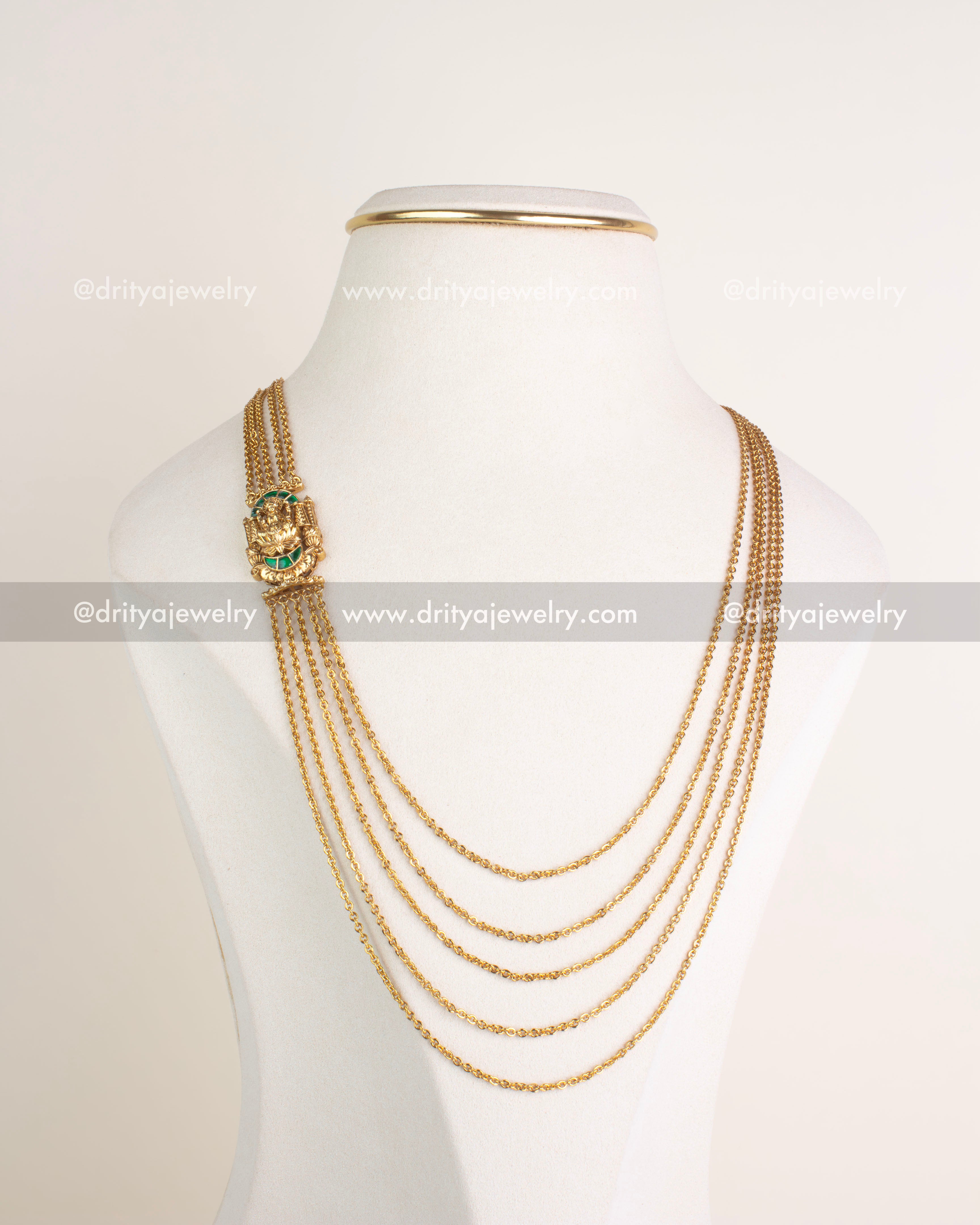 Full view of layered temple chandraharam necklace with side-set deity pendant on bust stand