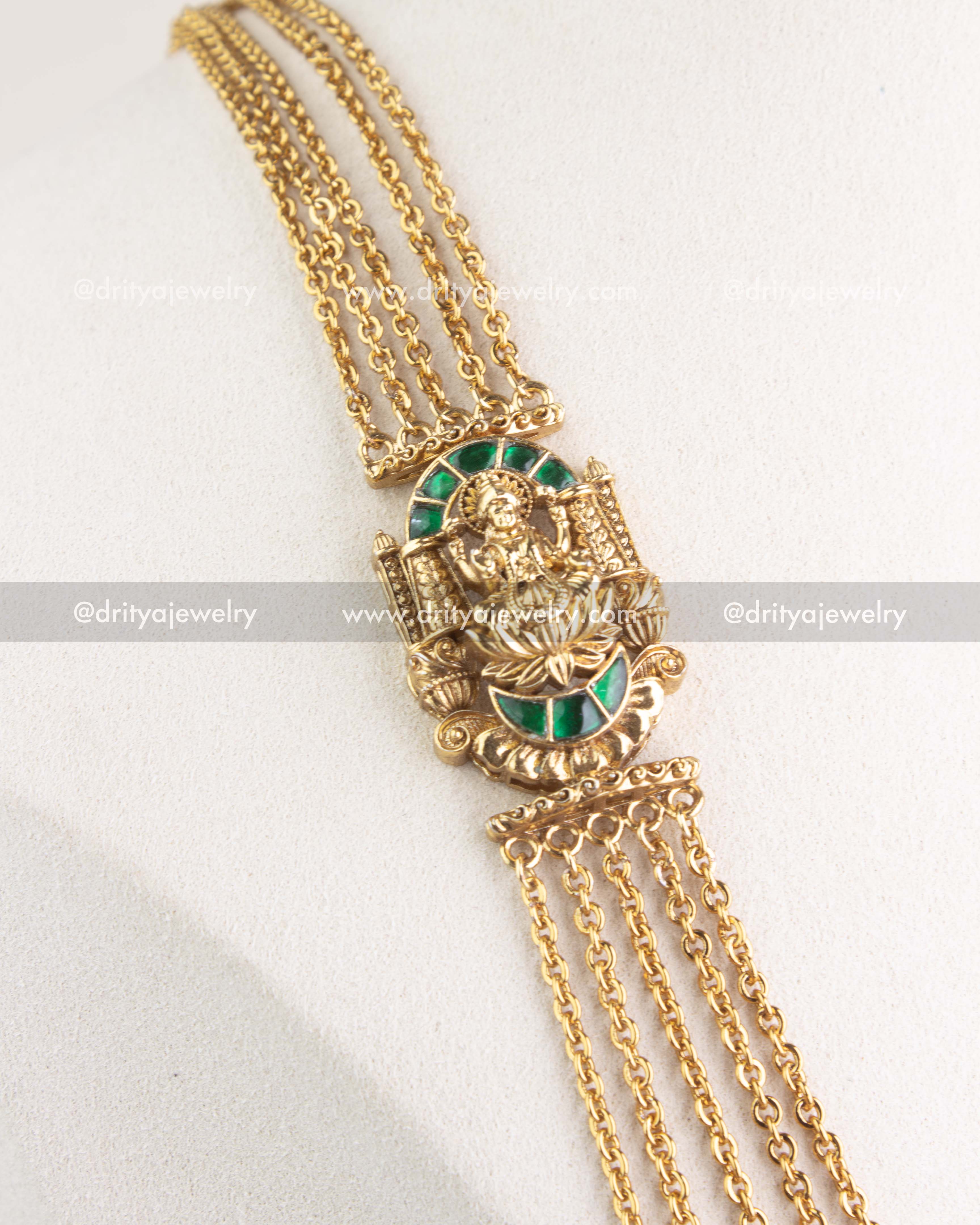 Layered gold-plated temple chandraharam necklace with green kemp god pendant close view