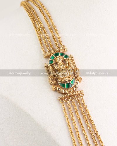 Layered gold-plated temple chandraharam necklace with green kemp god pendant close view