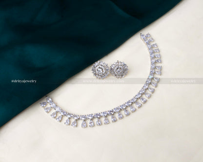 Elegant American Diamond short necklace set featuring teardrop detailing and radiant silver-tone finish with matching earrings.