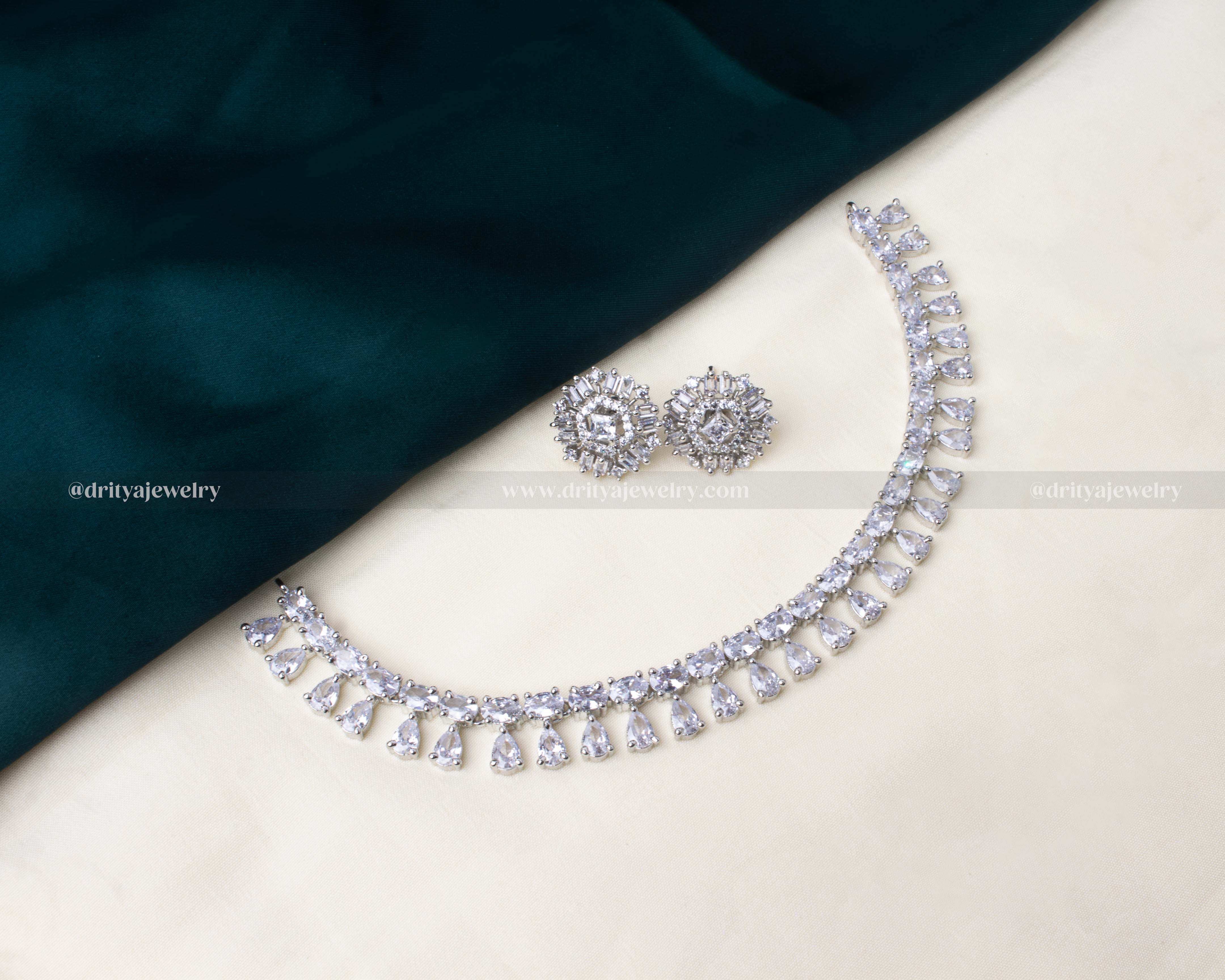 Elegant American Diamond short necklace set featuring teardrop detailing and radiant silver-tone finish with matching earrings.