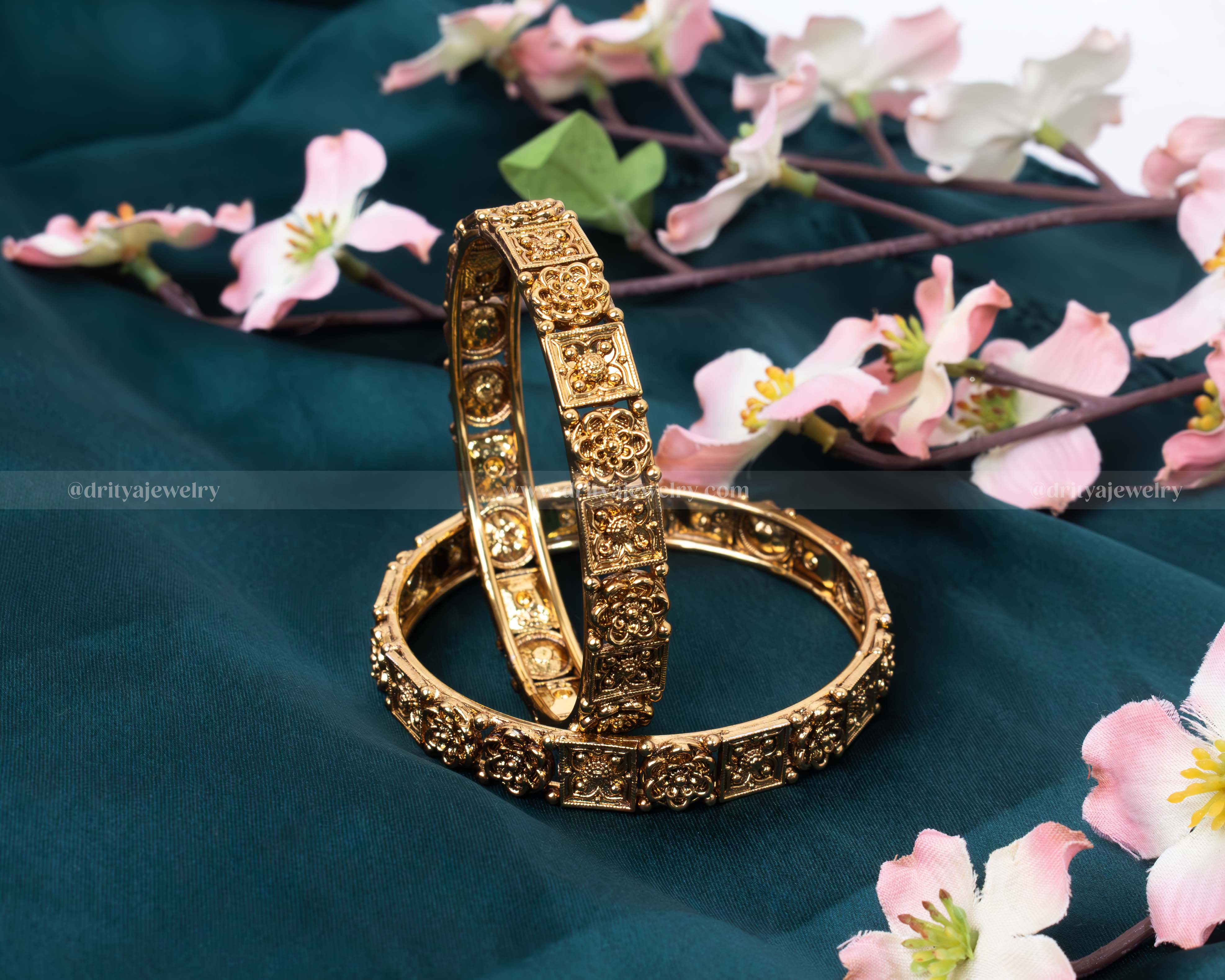 Showcasing Dritya Jewelry’s Antique Finish Bangle Set with intricate floral and paisley carvings in a vintage gold tone.