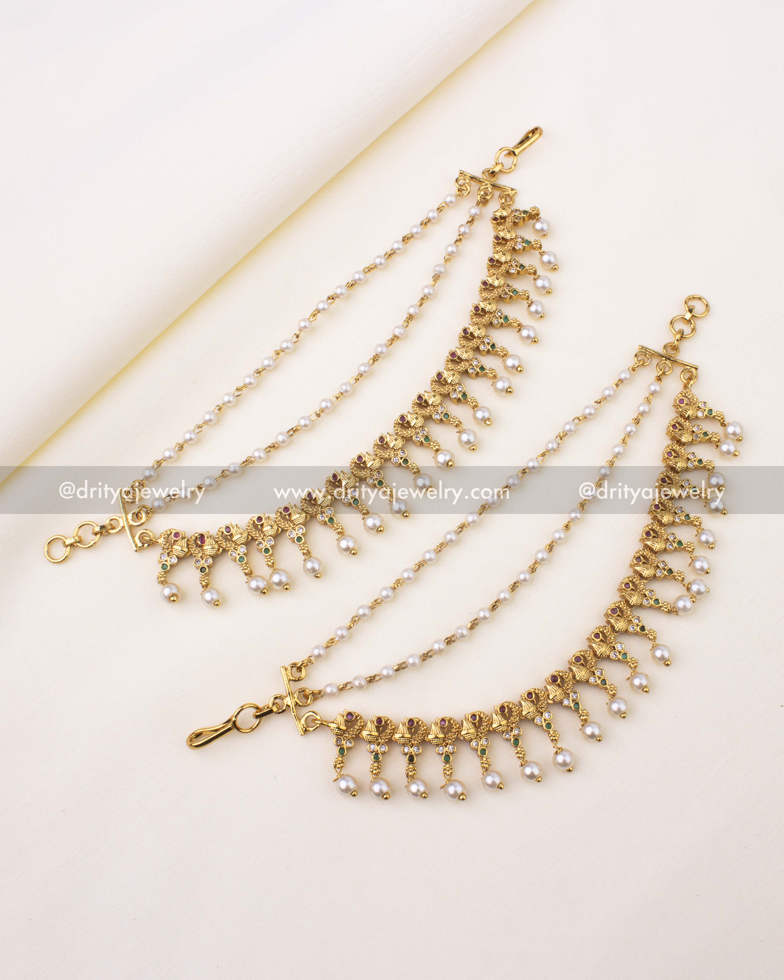 Antique gold champaswaralu featuring floral motifs, CZ stones, and pearl drops.
