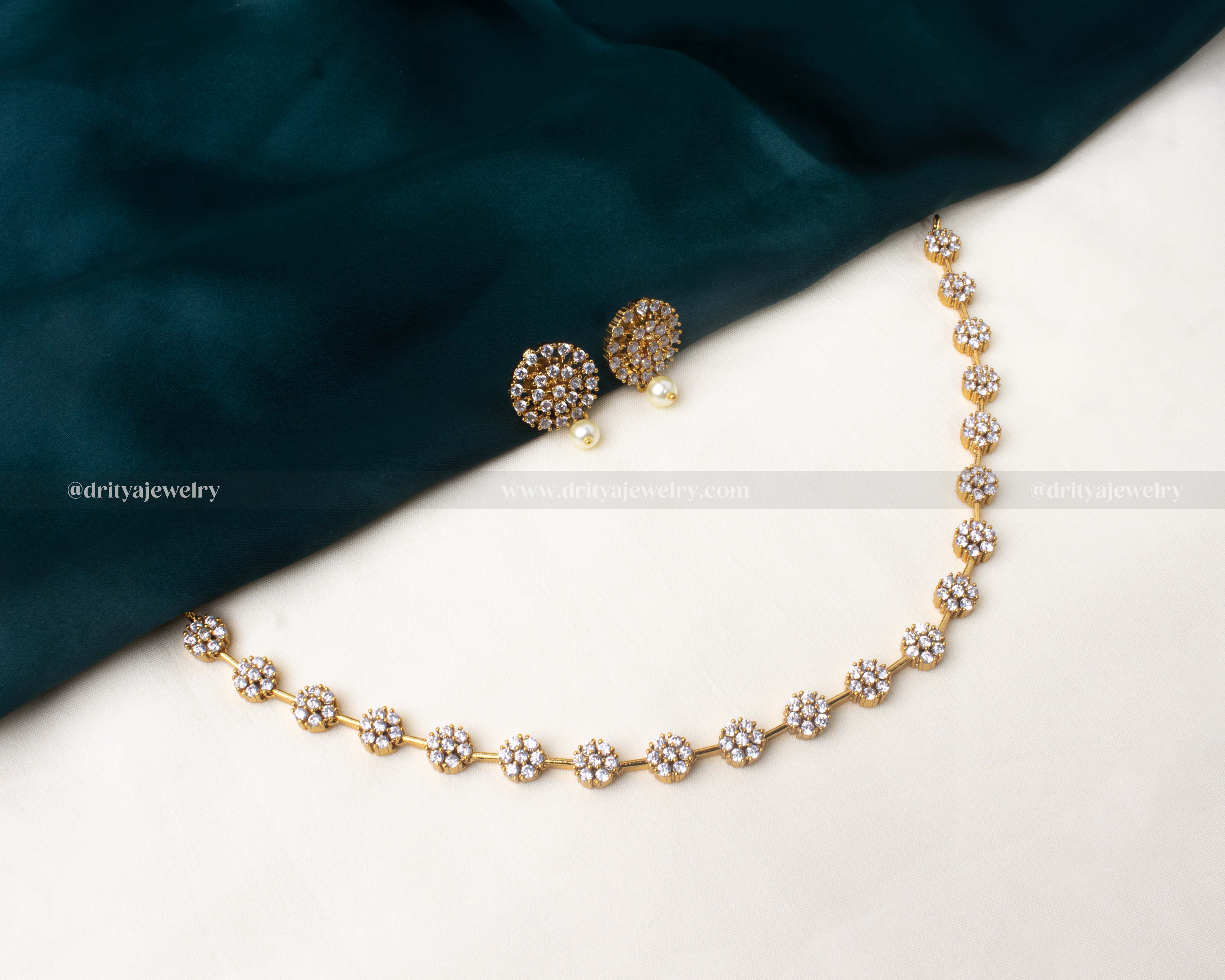 Antique finish short necklace with flower motif design and pearl-accented stud earrings, crafted in gold-tone finish.