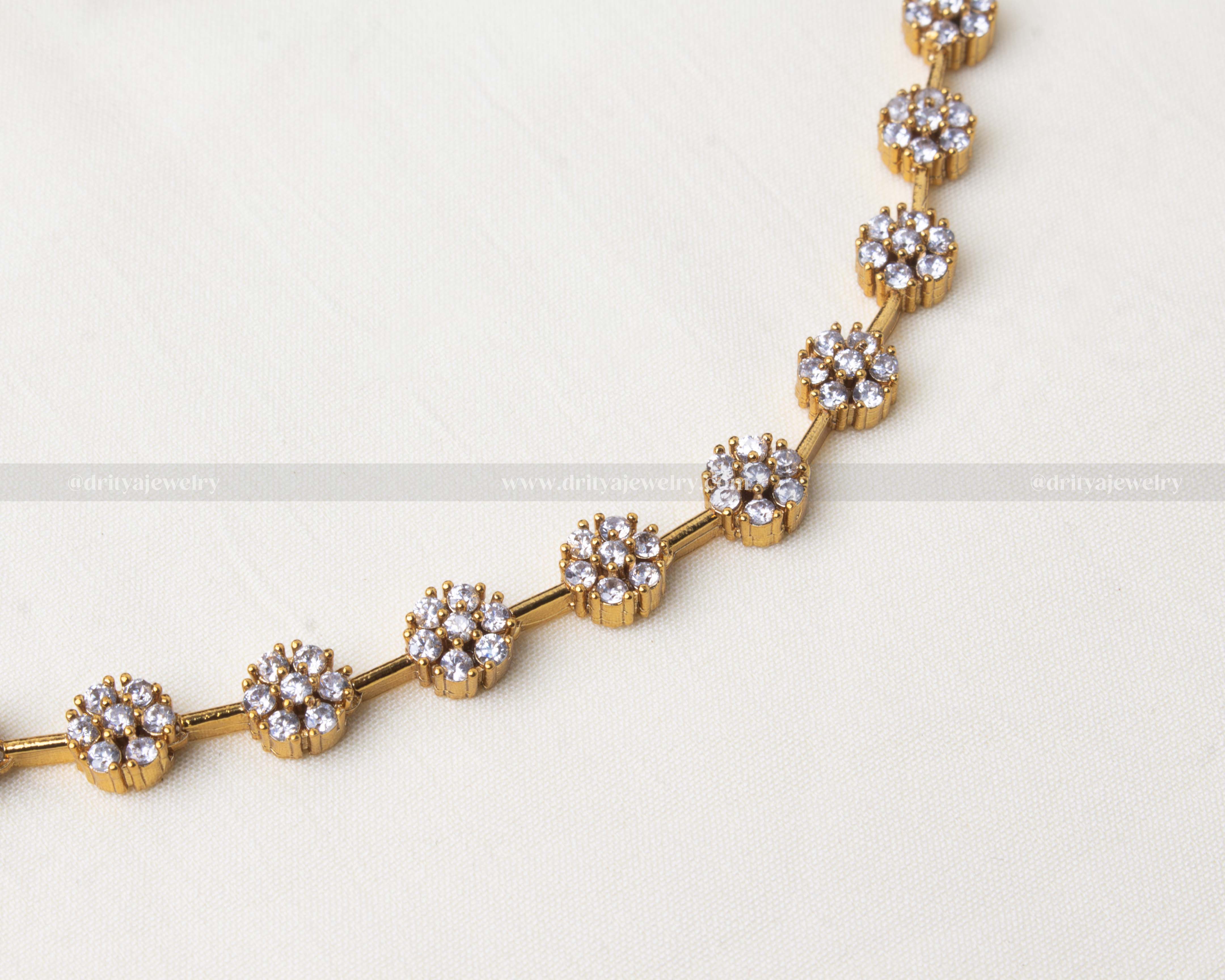 Antique finish short necklace with flower motif design and pearl-accented stud earrings, crafted in gold-tone finish.