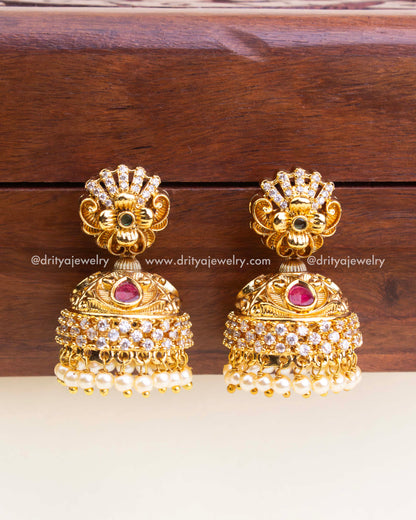 Traditional antique jhumka earrings with CZ stones, ruby accents, and pearl danglers - no deity design.