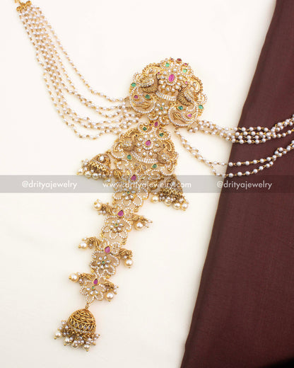 Mid-length antique jada billa featuring floral-peacock designs and layered pearl champaswaralu strands.